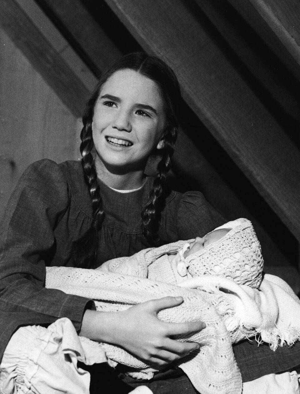 Melissa Gilbert holds a baby doll in a scene from "The Little House on the Prairie." | Source: Getty Images