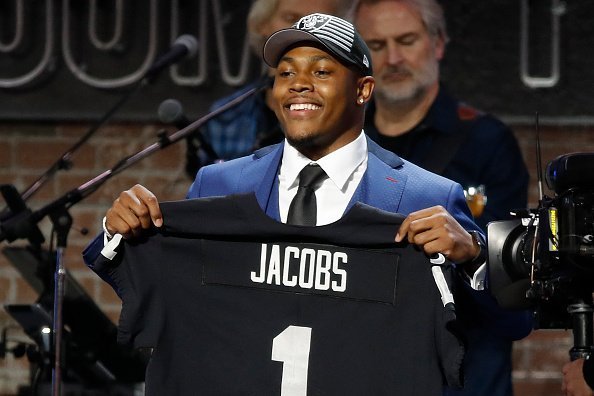 Josh Jacobs poses with a jersey after being selected by the Oakland Raiders with pick 24 on day 1 of the 2019 NFL Draft on April 25, 2019 | Photo: Getty Images