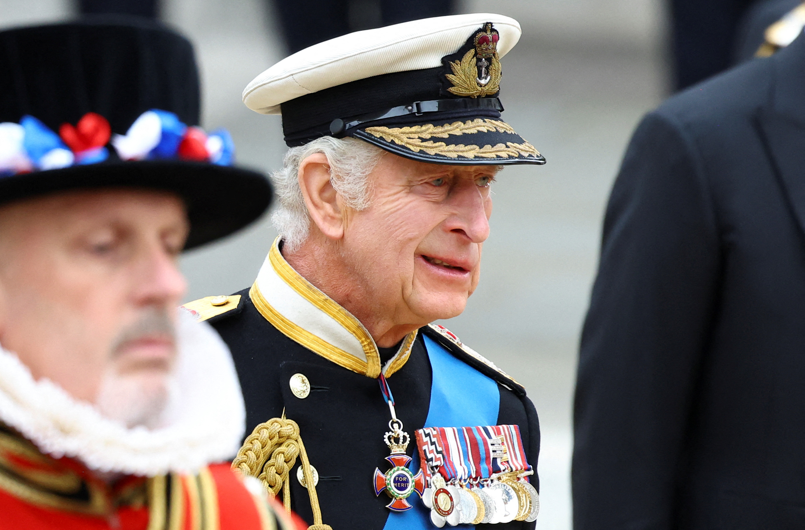 King Charles III follows a Bearer Party of The Queen's Company, 1st Battalion Grenadier Guards, carrying the coffin of Queen Elizabeth II outside Westminster Abbey in London on September 19, 2022. | Source: Getty Images