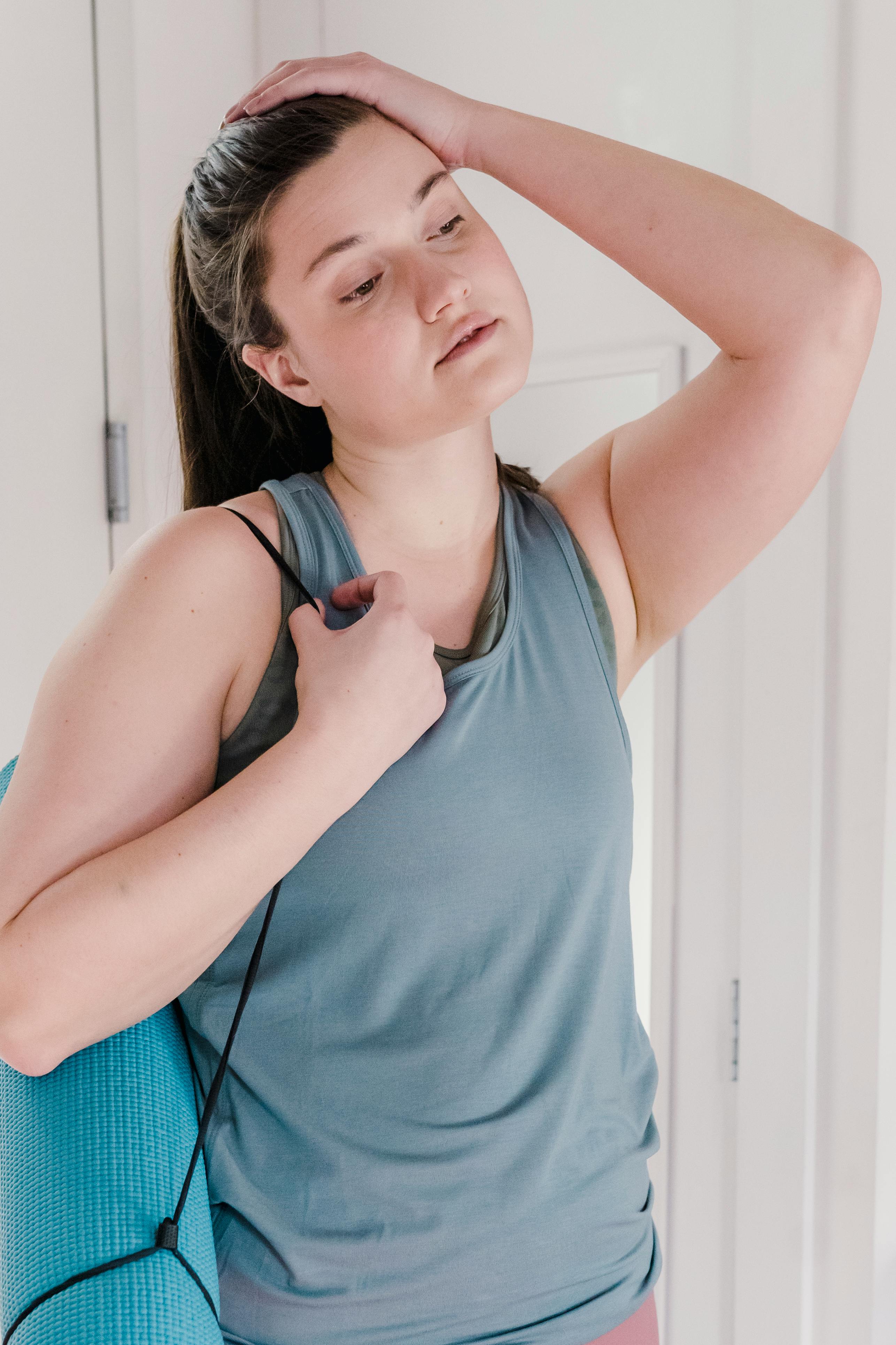 A tired woman catching her breath after a workout session. | Source: Pexels