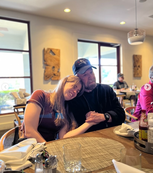Chuck Norris shares a warm moment with his daughter Danilee at a restaurant | Source: Instagram/d.ani.lee