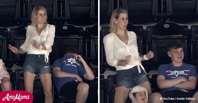 Teen looks absolutely mortified by mom's awesome jumbotron dance