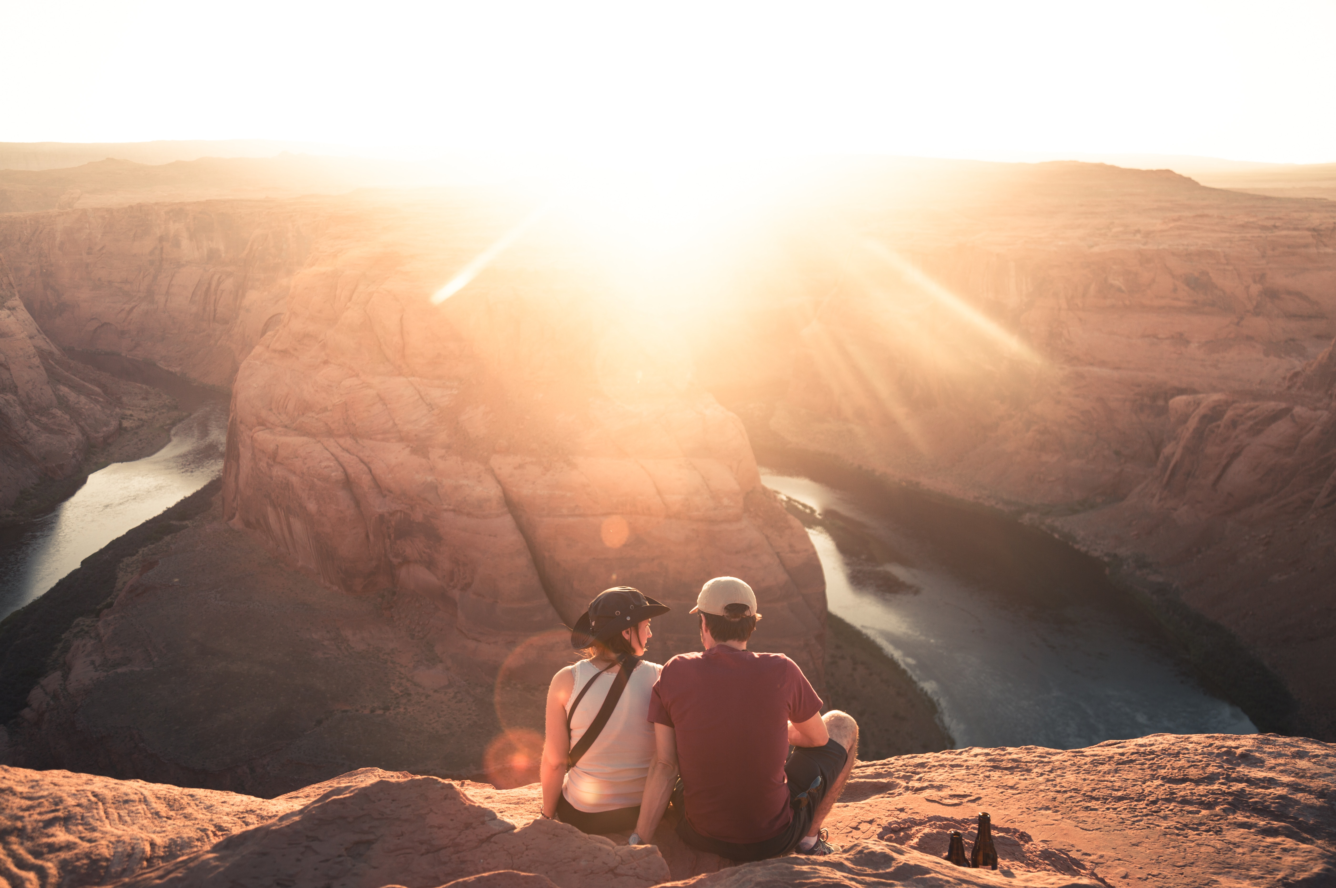 A photo of a man and a woman sitting on rock formation | Source: Unsplash