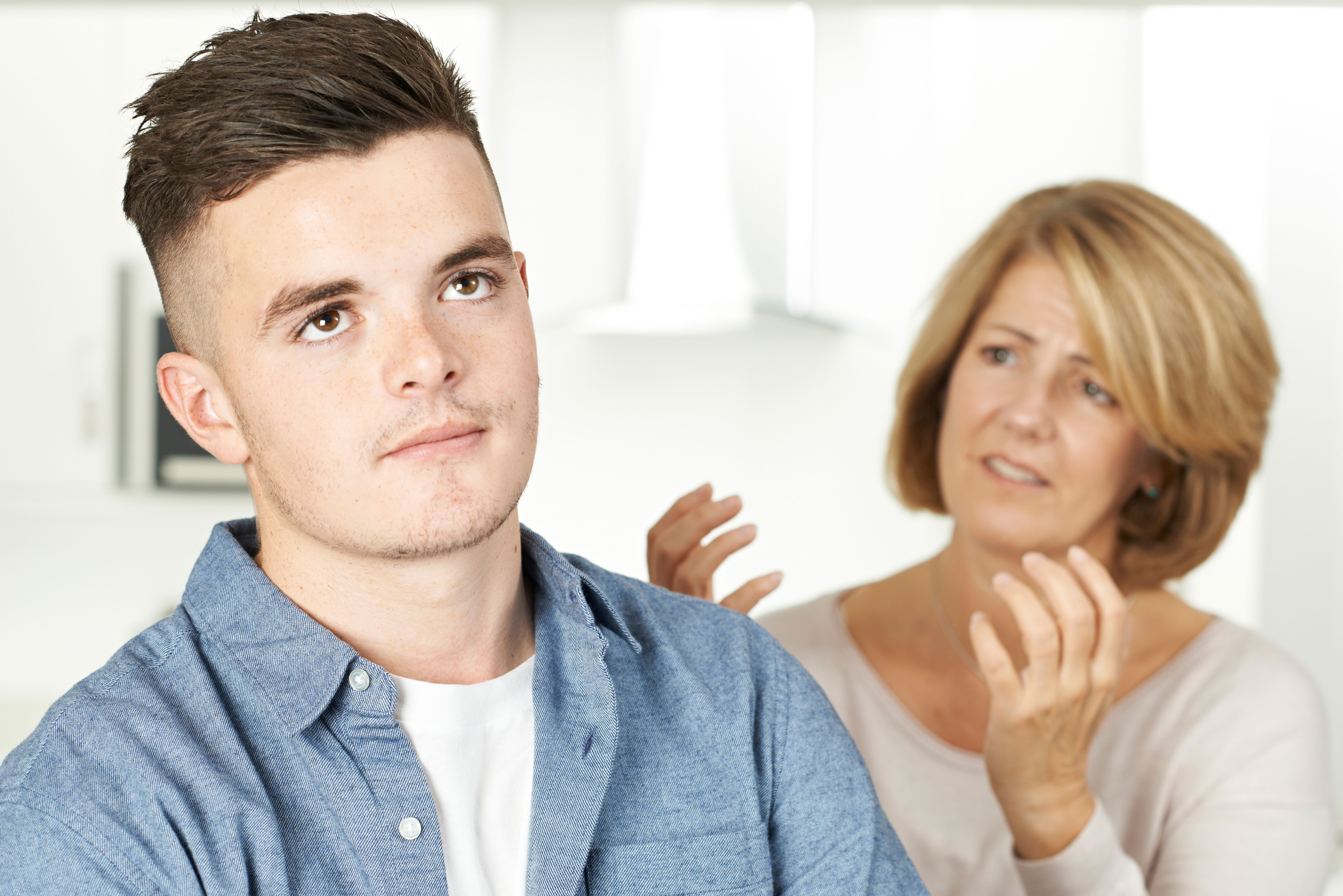 A woman talking to a young man | Source: Shutterstock