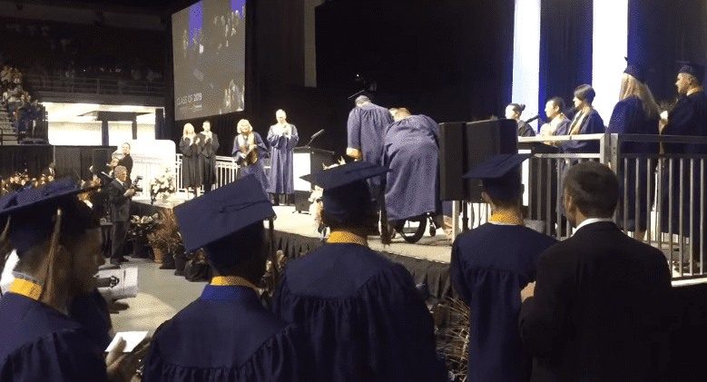 Kolton Smith, the paralyzed high school student walking to receive diploma on stage.| Photo: Facebook/ Hillsborough County Public Schools. 