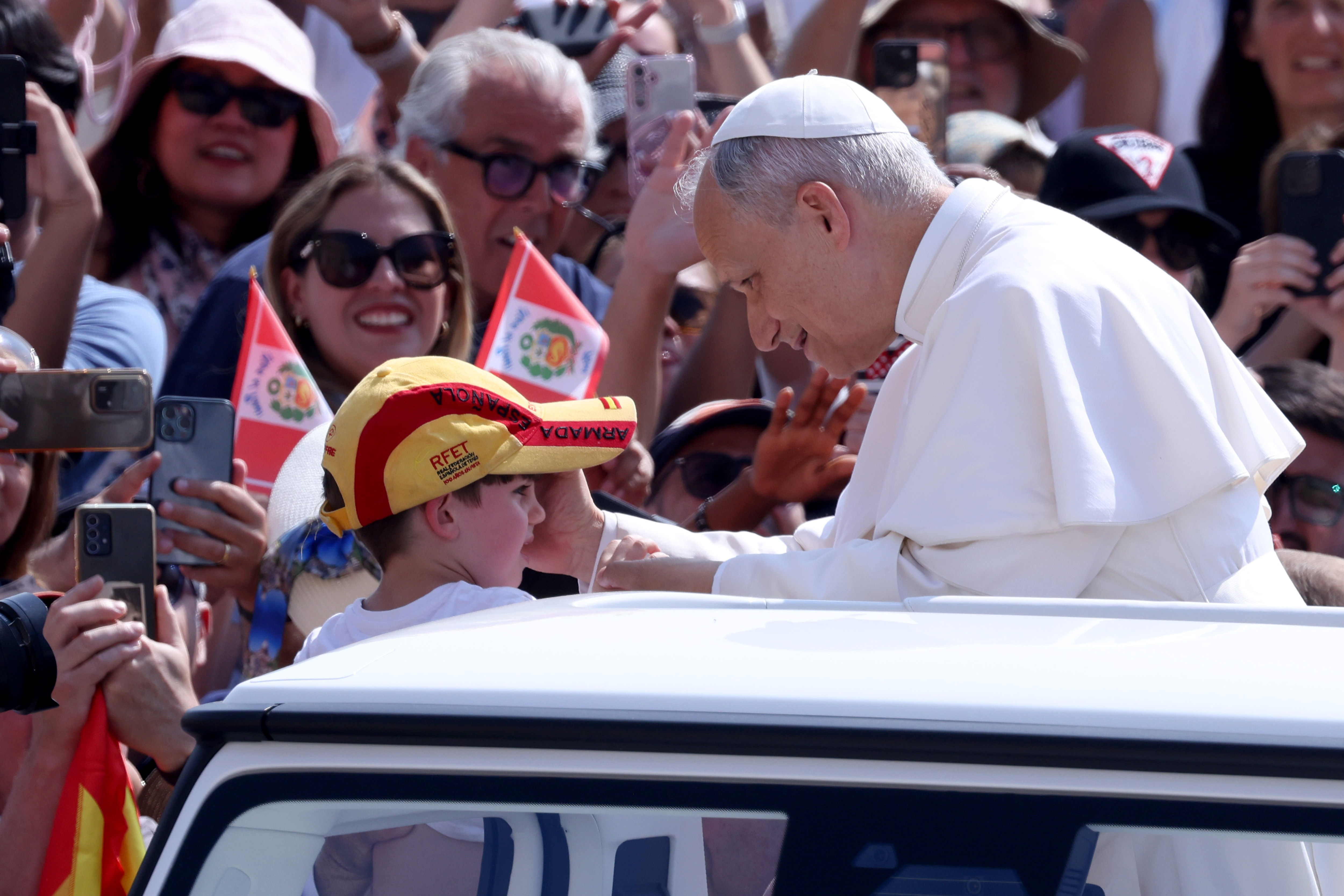 Pope Leo XIV greets a young boy wearing a cap as pilgrims look on at St. Peter's Square on June 11, 2025 | Source: Getty Images