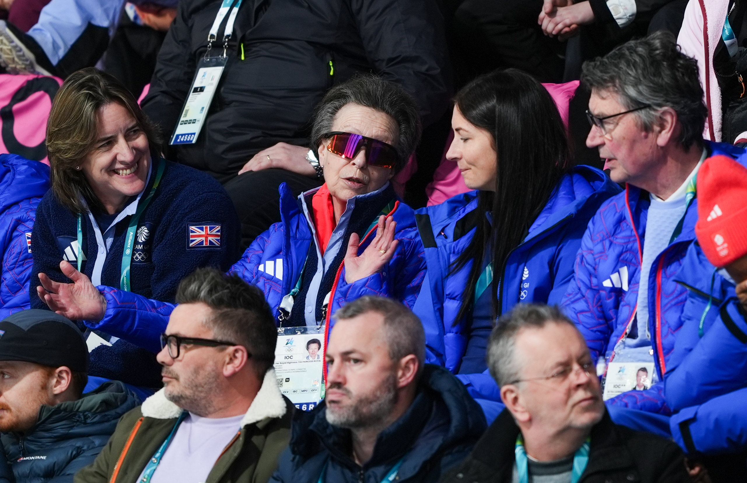 Seated alongside fellow Team GB representatives, the Princess Royal leaned into animated conversation during the same bronze medal clash, gesturing mid-point as she followed the action stone by stone. Her electric blue outerwear — stitched with bold detailing and the Team GB lion — stood out sharply against the packed stands, while her wrap-around lenses added a flash of colour to an otherwise tense afternoon.
