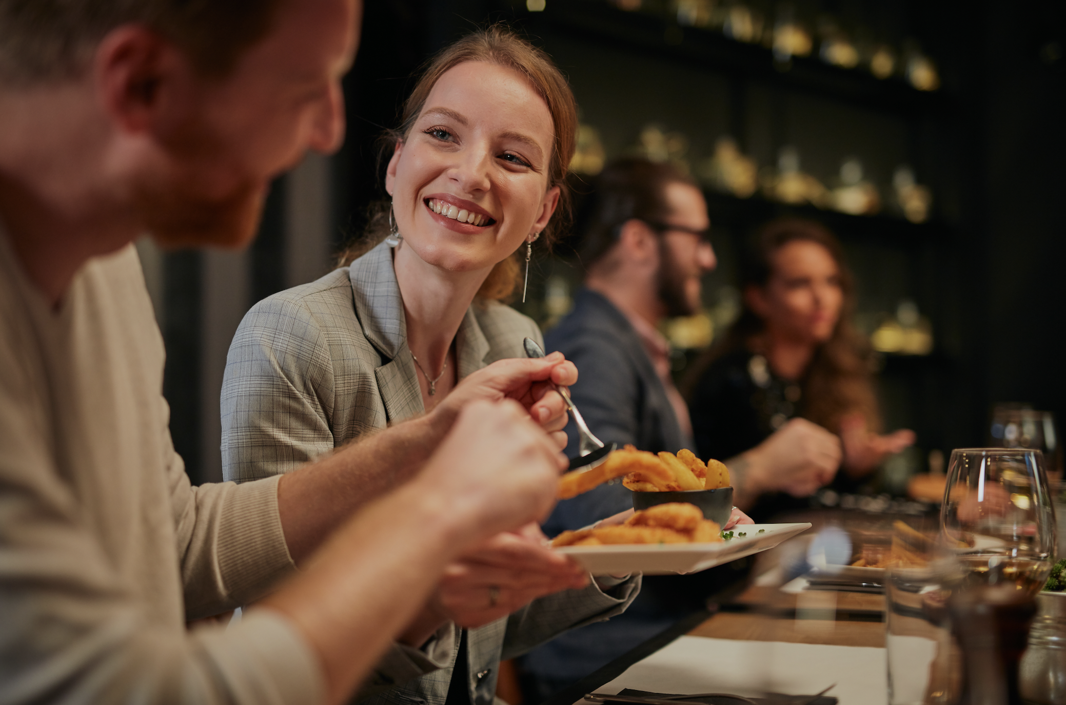 A young woman smiles to the man in the restaurant | Source: Shutterstock