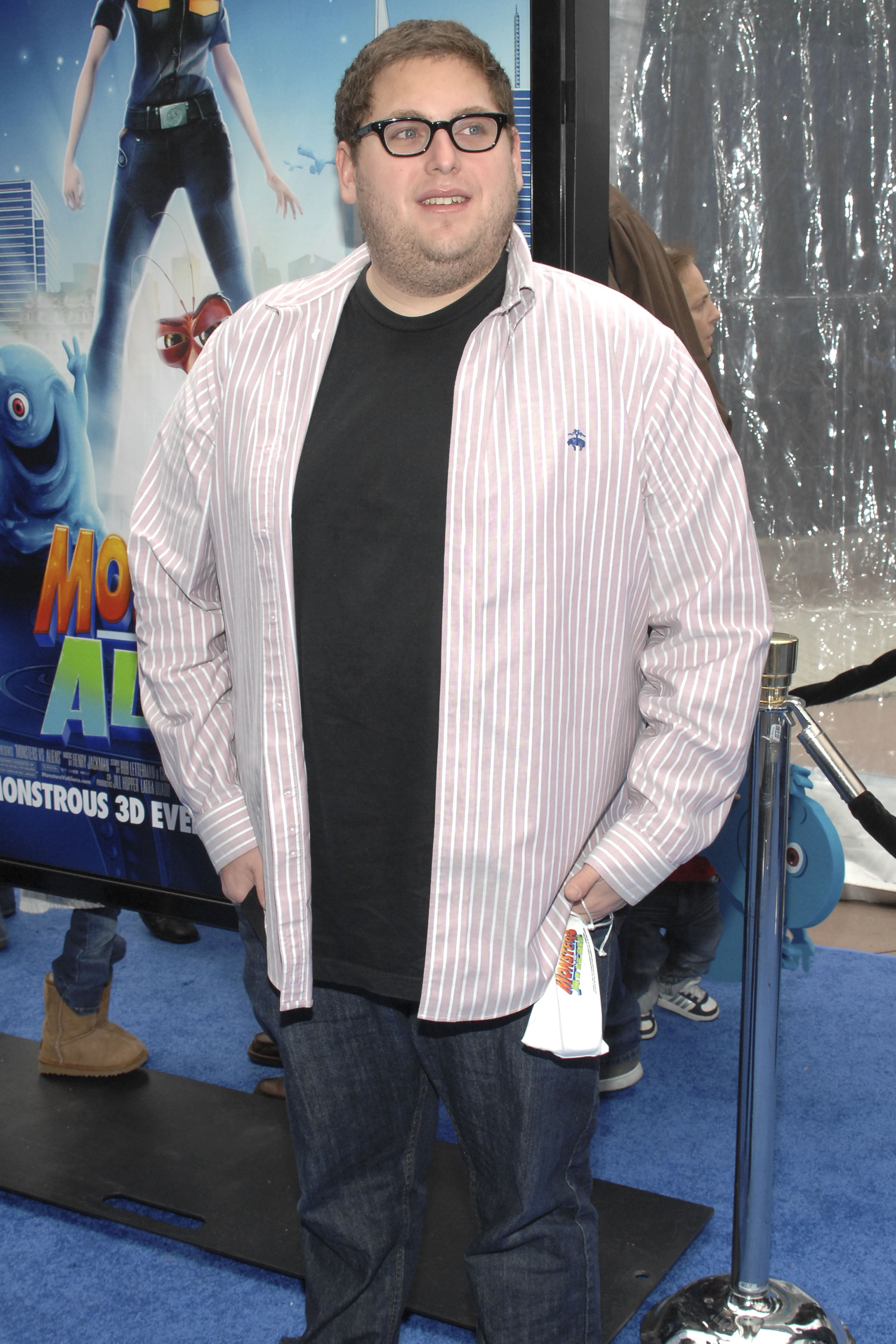 Jonah Hill arrived at the Los Angeles premiere of "Monsters vs. Aliens" at the Gibson Amphitheatre in Universal City, California, on March 22, 2009. Wearing black-framed glasses, jeans, and a pink-and-white striped shirt layered over a black T-shirt, the actor displayed the fuller build that characterized much of his early career — two years before he unveiled the results of a roughly 40-pound weight loss.