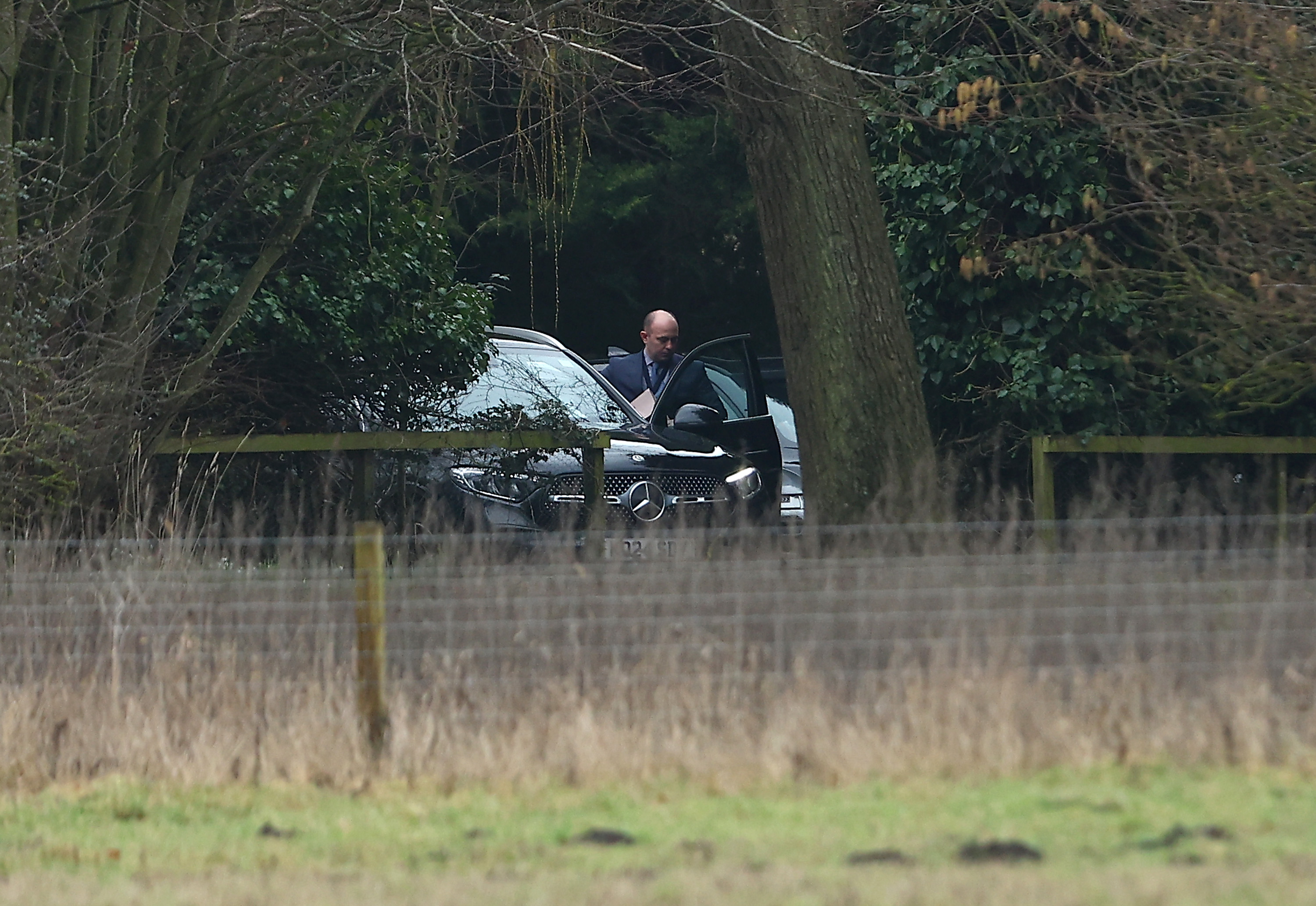 A man steps out of umarked car at the home of Andrew Mountbatten-Windsor on February 19, 2026 in Sandringham, Norfolk | Source: Getty Images