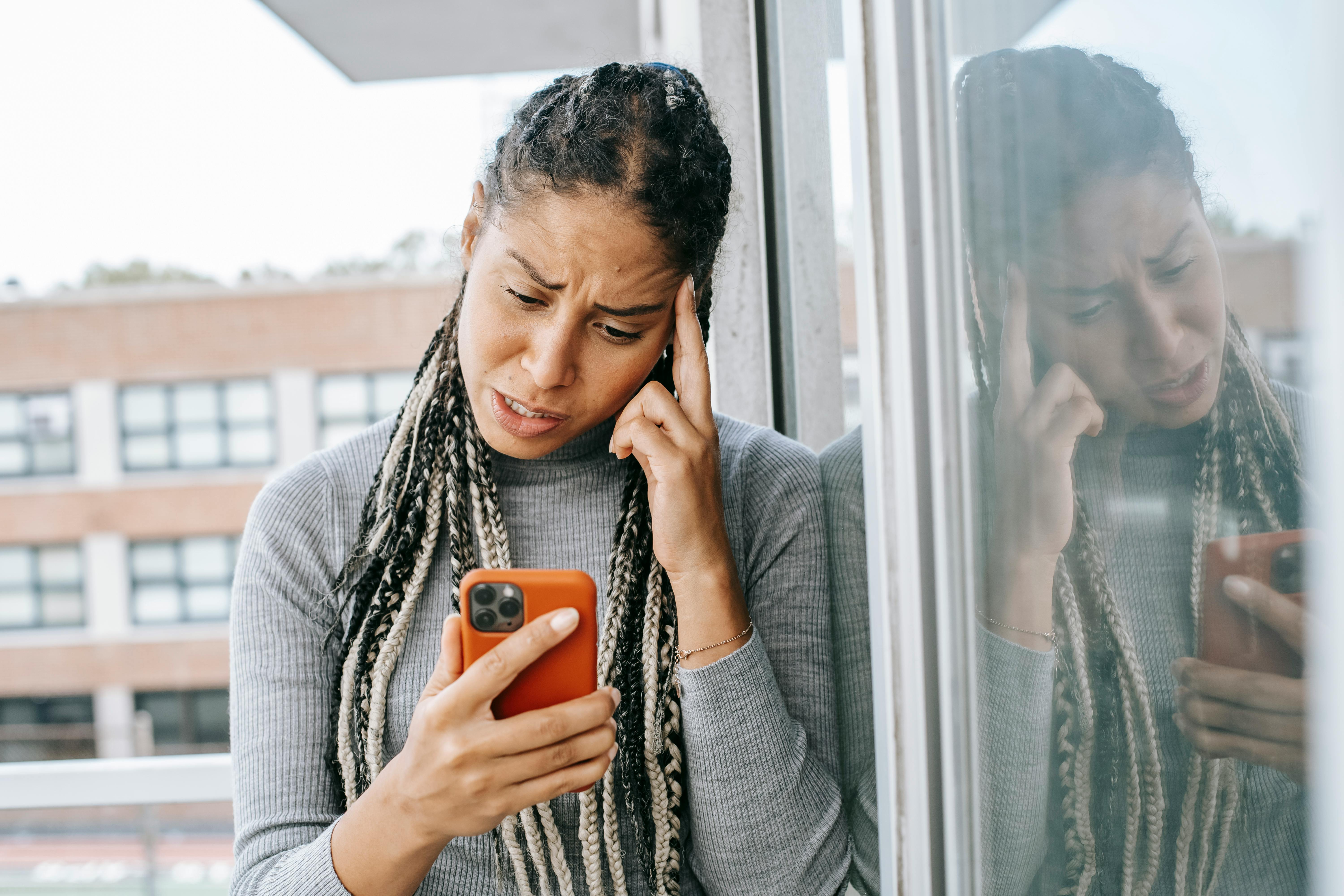 A woman looking upset while talking on a phone | Source: Pexels
