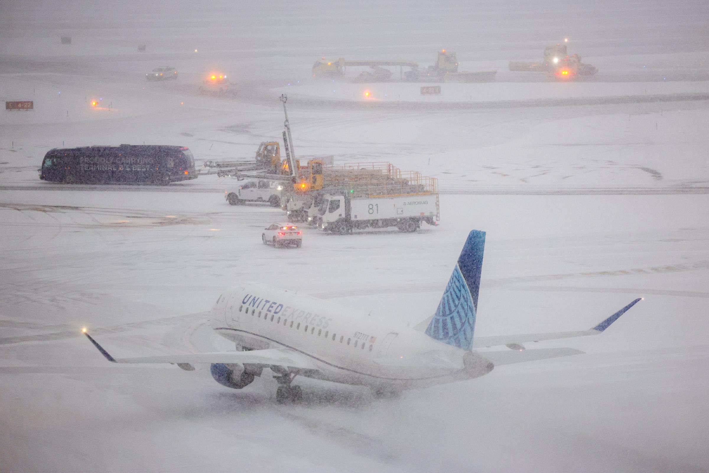 An Embraer 175 of United airlines taxies to take off as the snow falls on the tarmac of LaGuardia airport in New York on January 25, 2026 | Source: Getty Images
