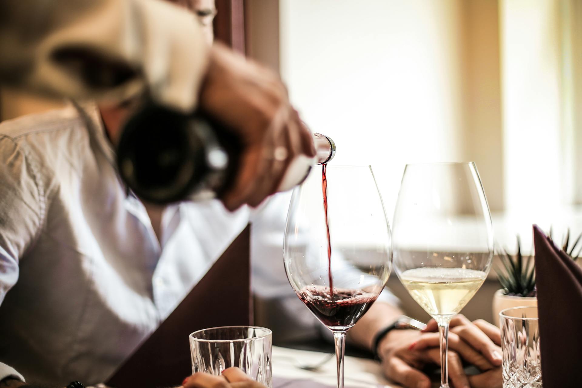 A person pouring wine at a restaurant | Source: Pexels
