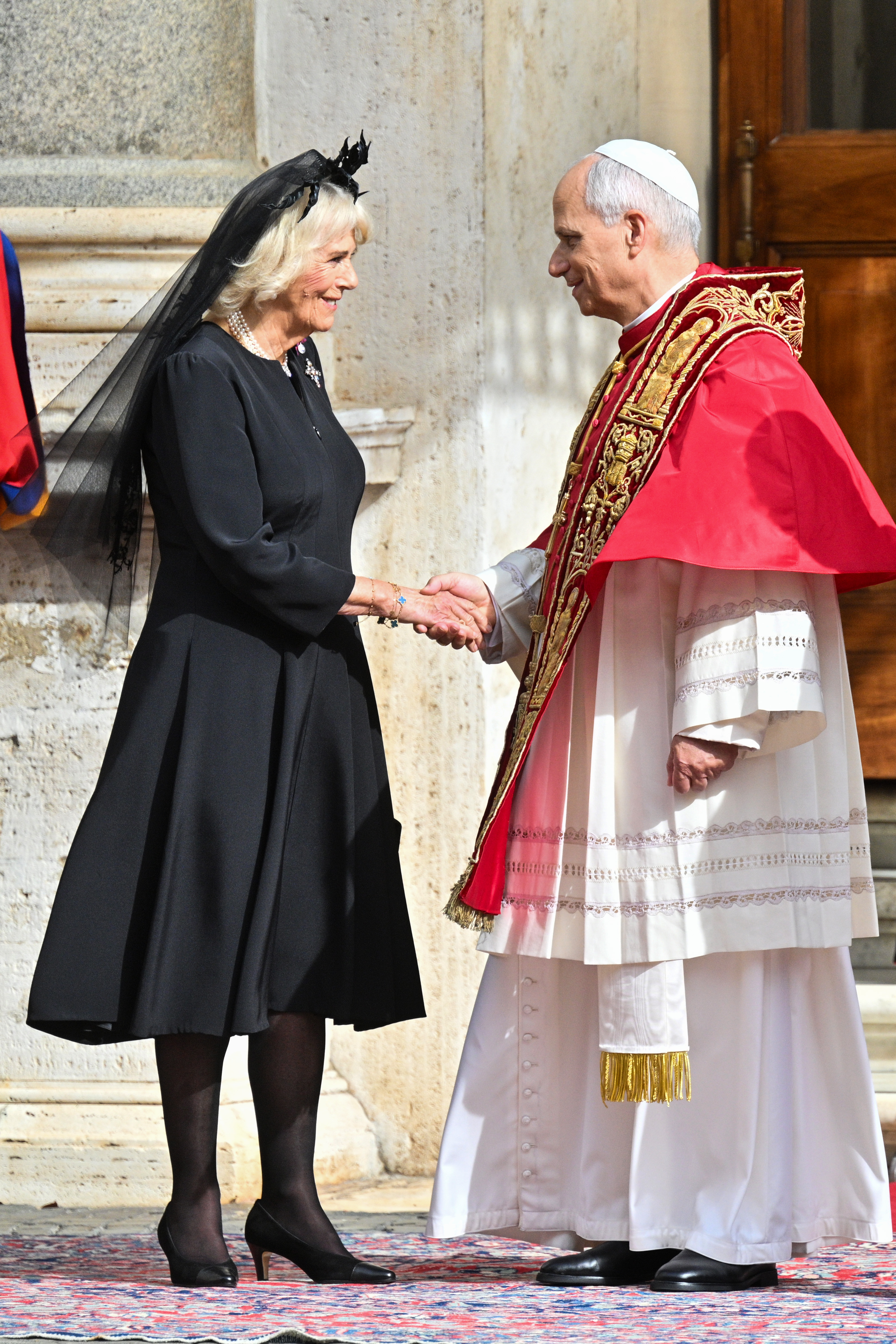 Queen Camilla shakes hands with Pope Leo XIV in San Damaso Courtyard on October 23, 2025 in Vatican City | Source: Getty Images