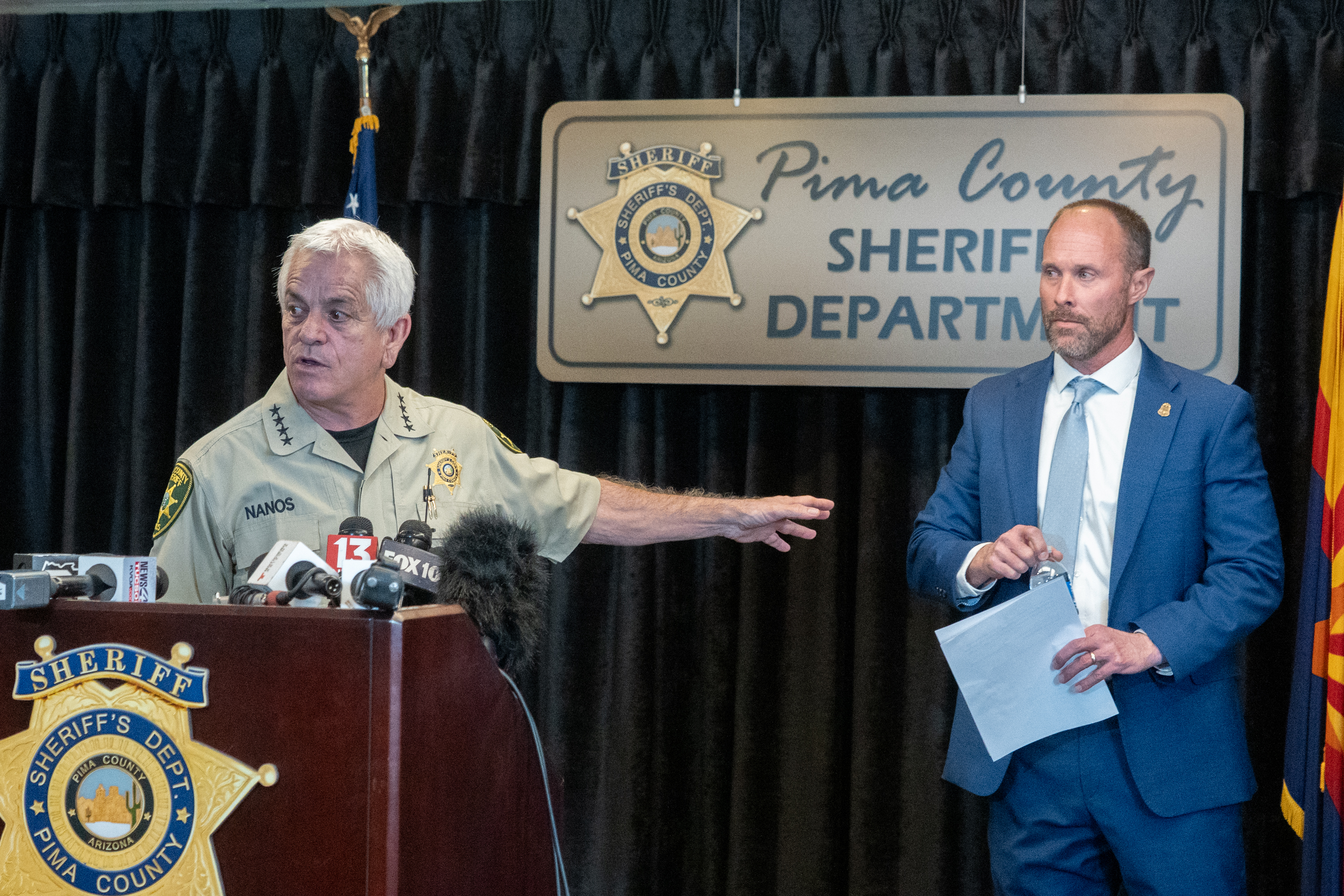 , Chris Nanos (left) and FBI assistant special agent in-charge Jon Edwards (right),  answering questions about the search for Nancy Guthrie in Tucson, Arizona  on February 3, 2026. | Source: Getty Images