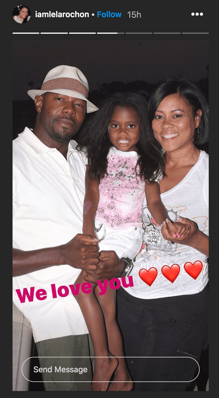 Lela Rochon, posing with her husband Antoine Fuqua as he carried their daughter, Asia Fuqua, in his arms | Source: instagram.com./iamlelarochon