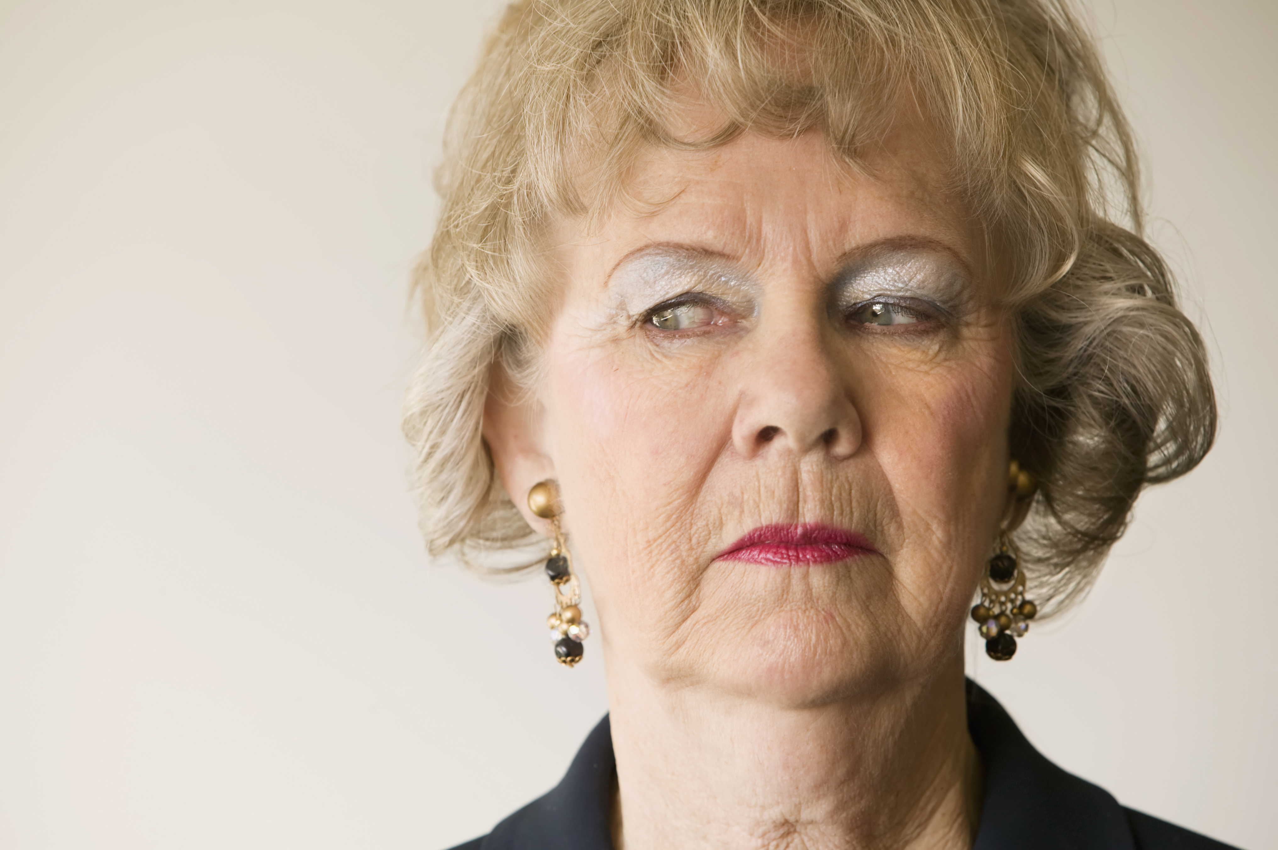 An angry elderly woman looking sideways | Source: Shutterstock