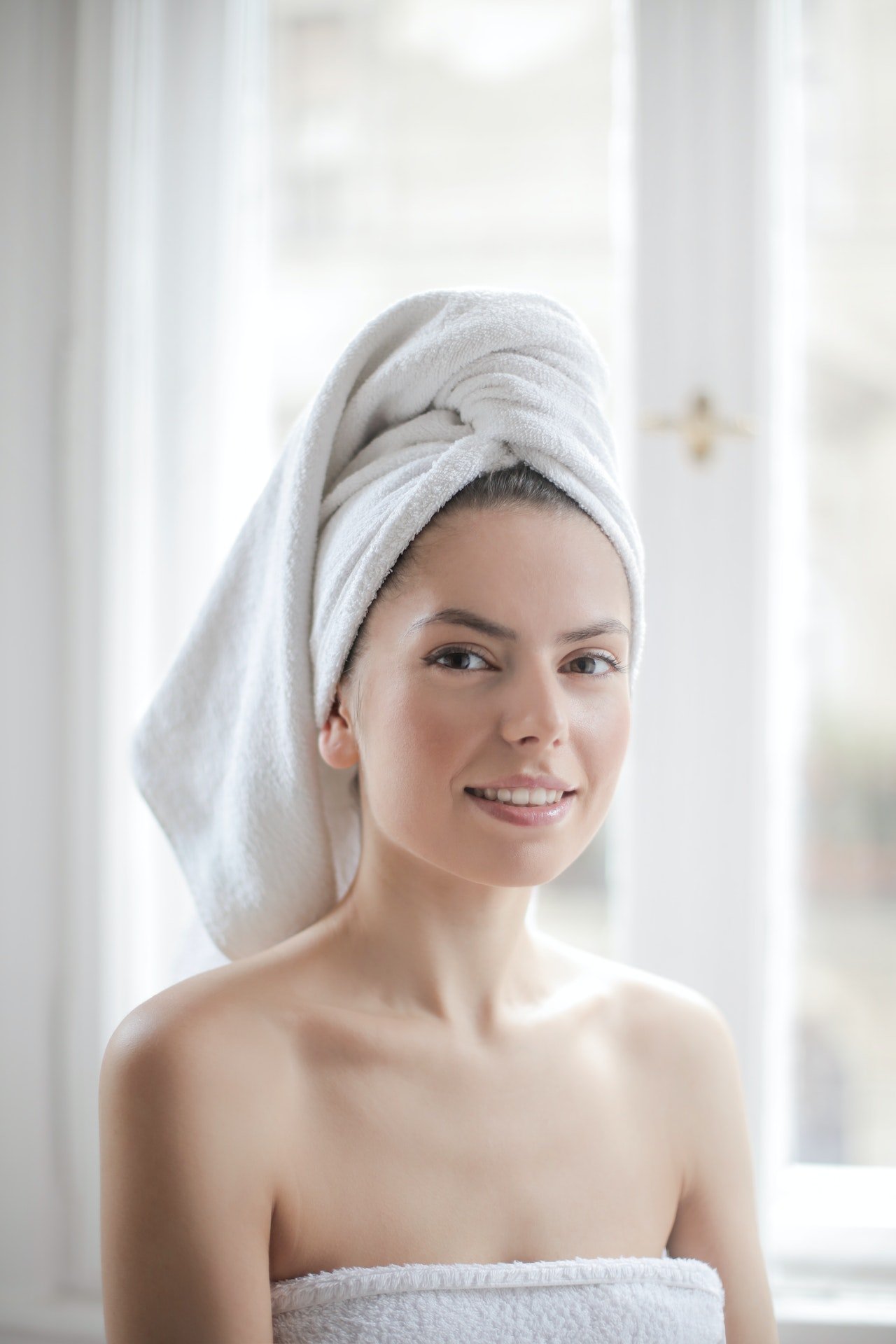 Photo of a woman with white towel on her head | Photo: Pexels