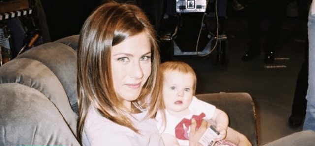 Jennifer Aniston holding one of the Sheldon twins for an episode of "Friends" | Photo: YouTube/Access