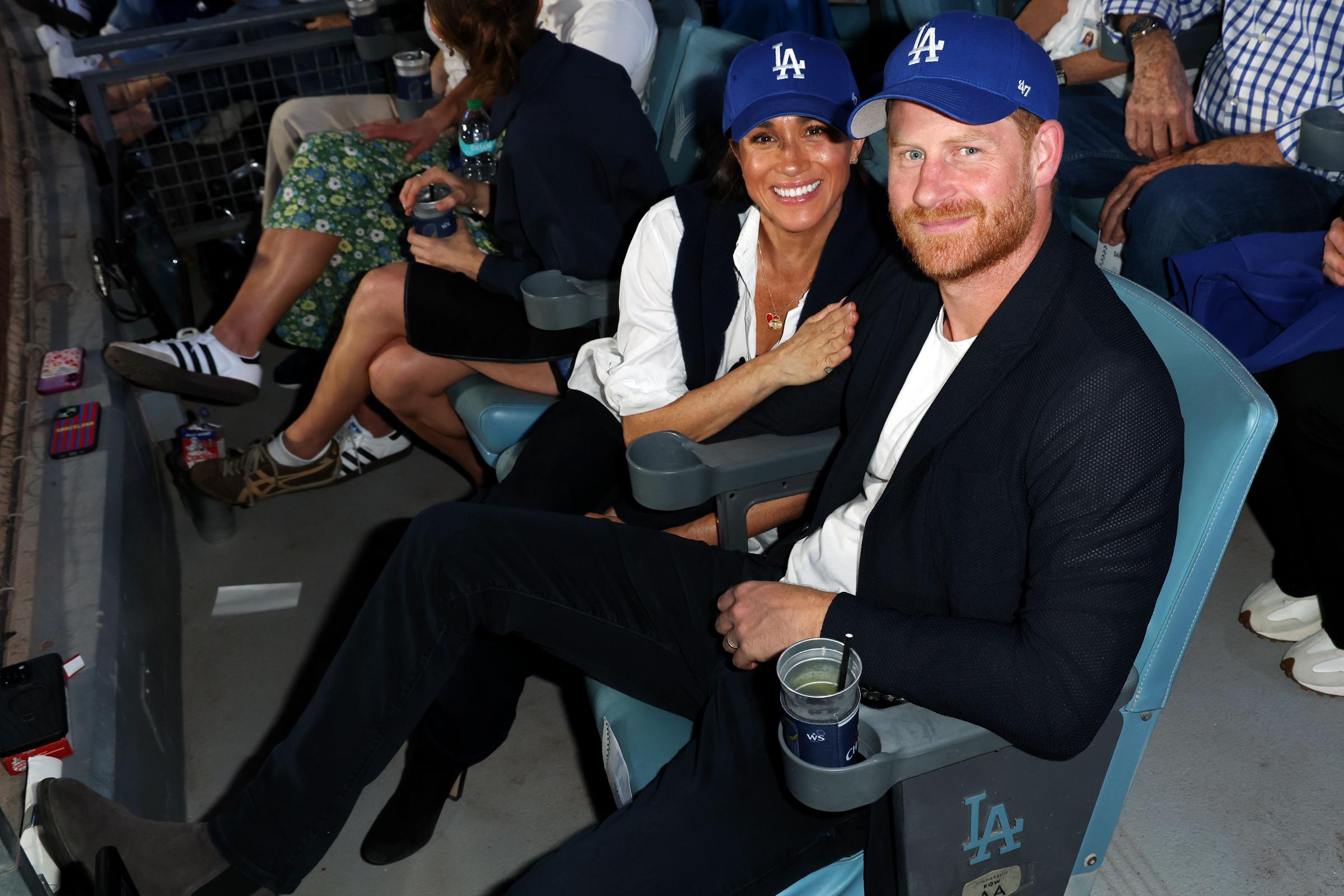 Meghan Markle and Prince Harry smiling for cameras. | Source: Getty Images