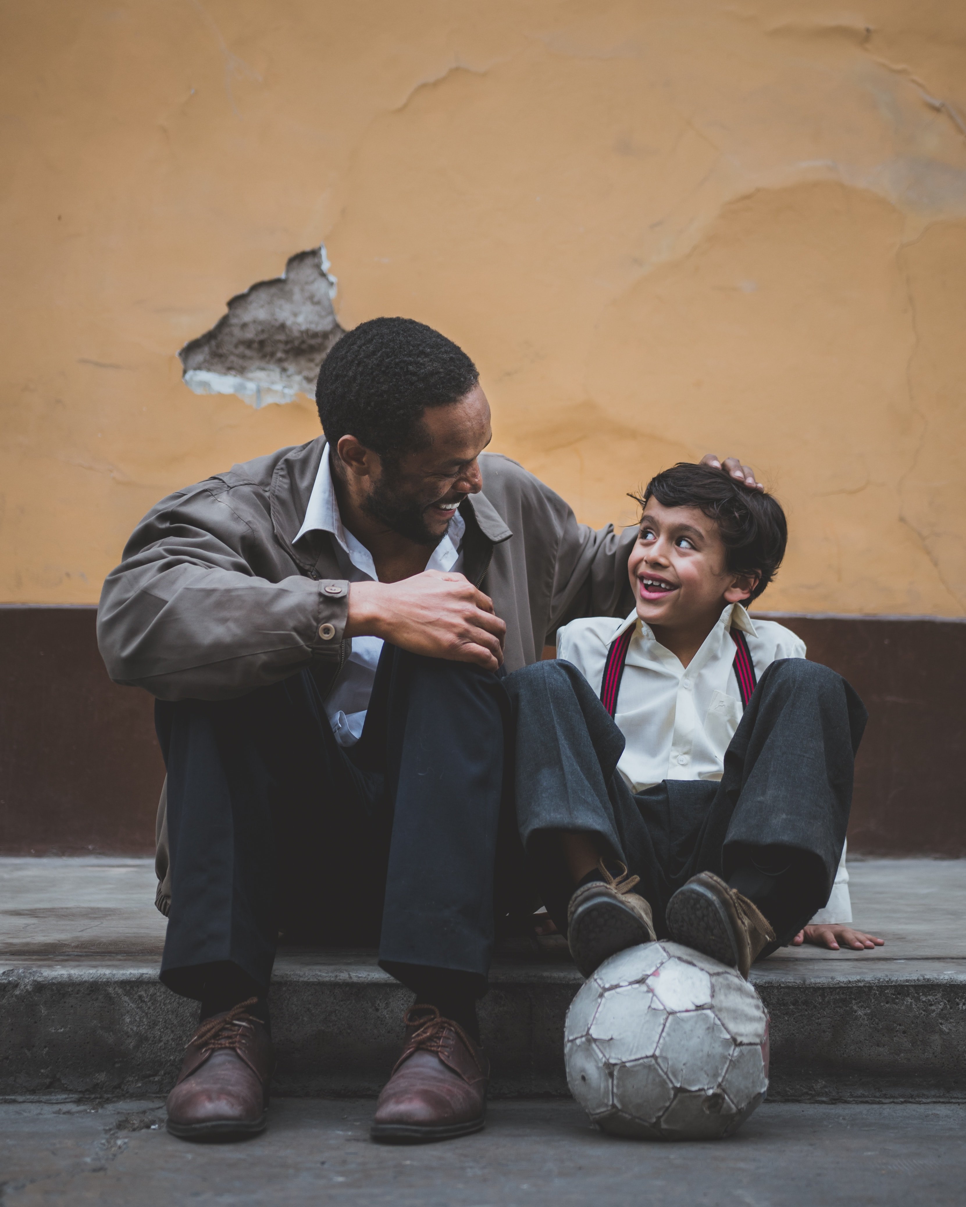 Father and son smiling at each other. | Source: Upsplash/Sebastián León Prado