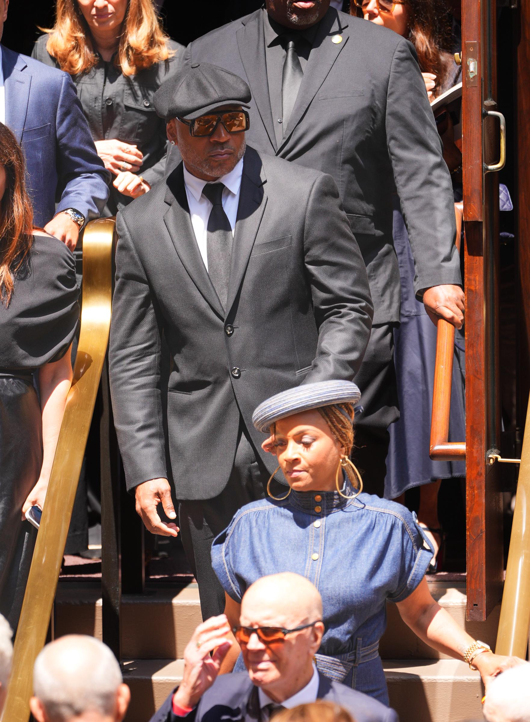 LL Cool J and his wife, Simone Smith, departed the service together as the rapper's distinguished new look continued to draw praise online. | Source: Getty Images