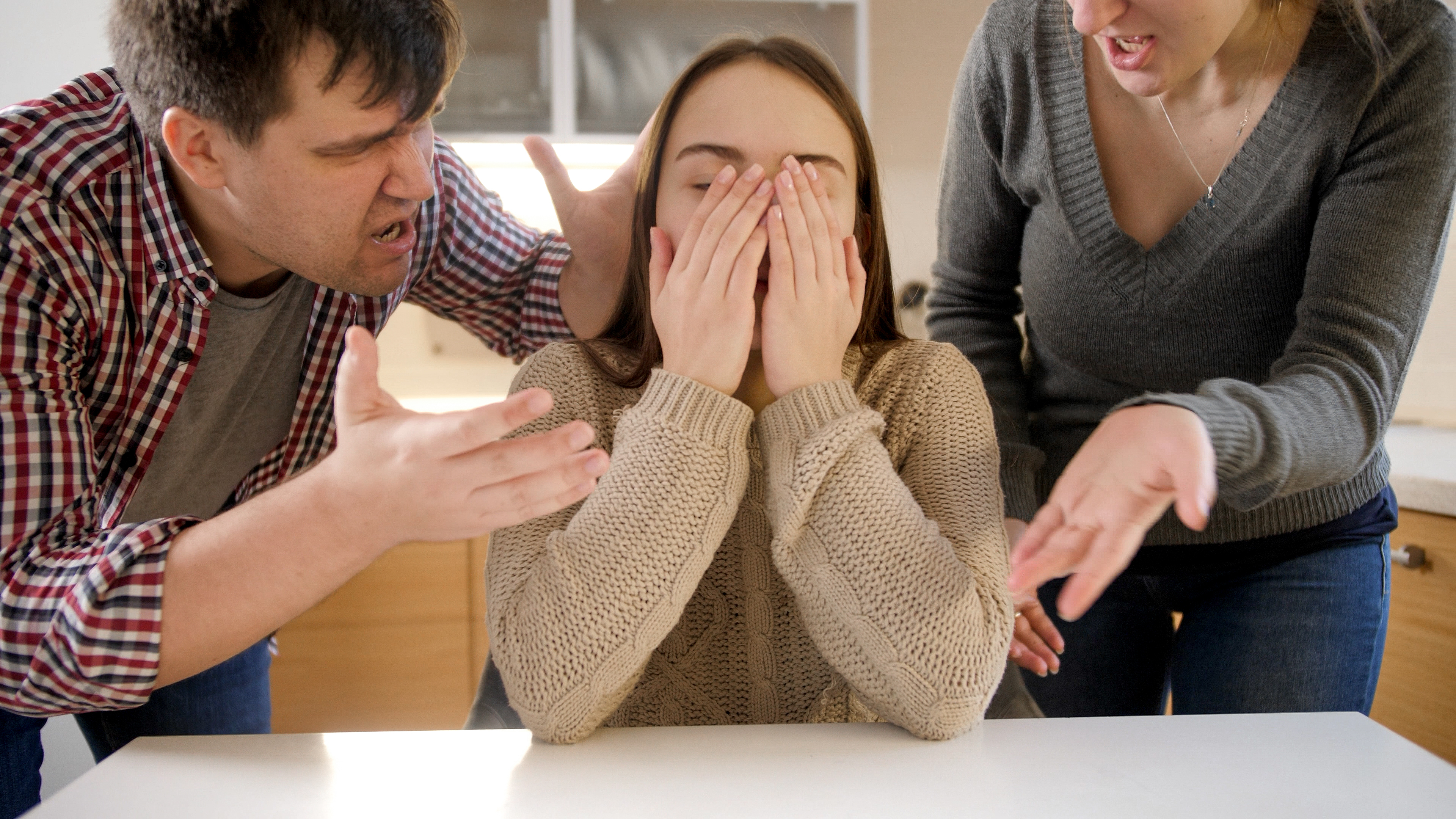 A teenage girl crying after a conflict with her parents | Source: Shutterstock