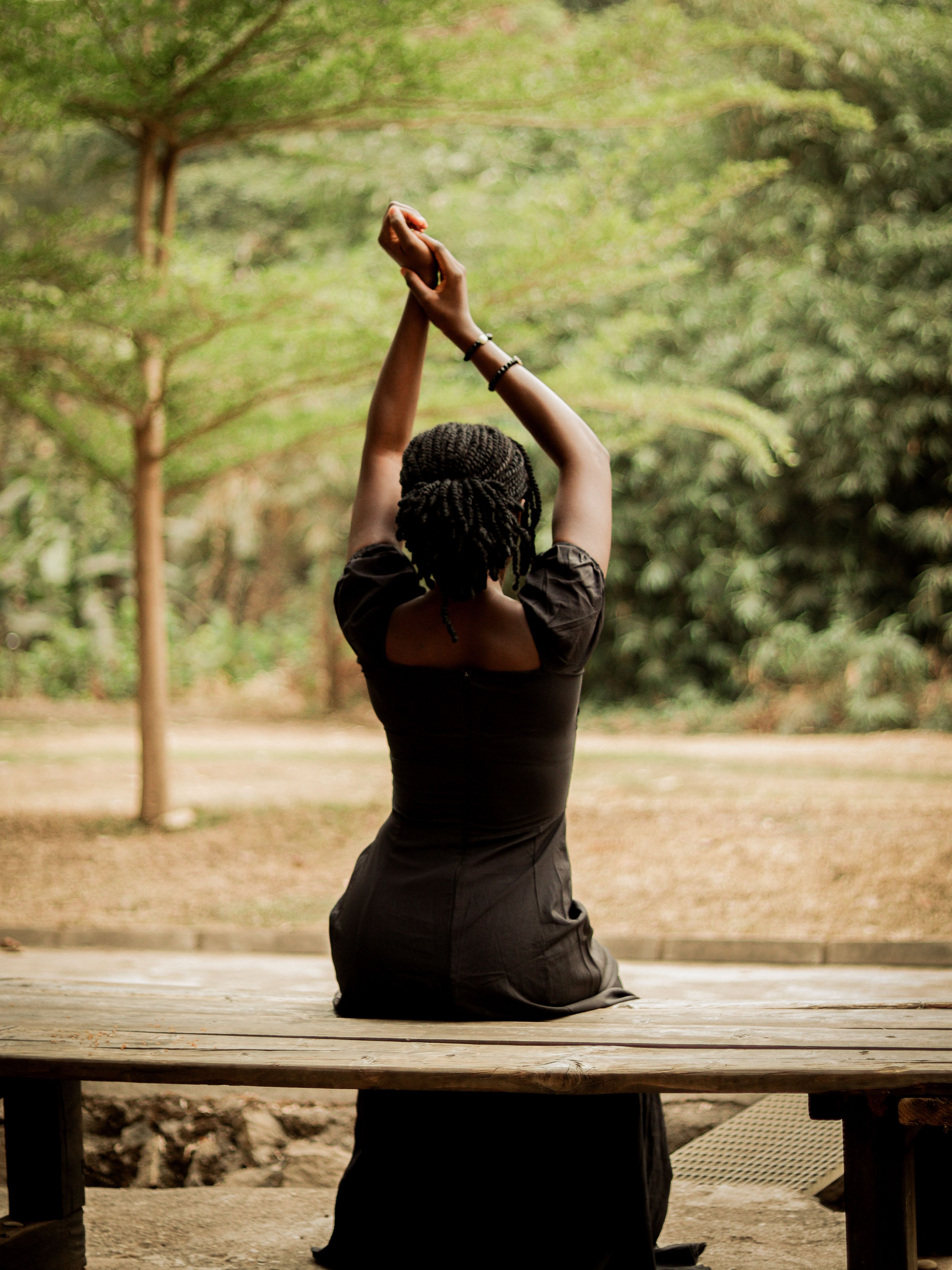 A woman stretching her arms outdoors | Source: Pexels