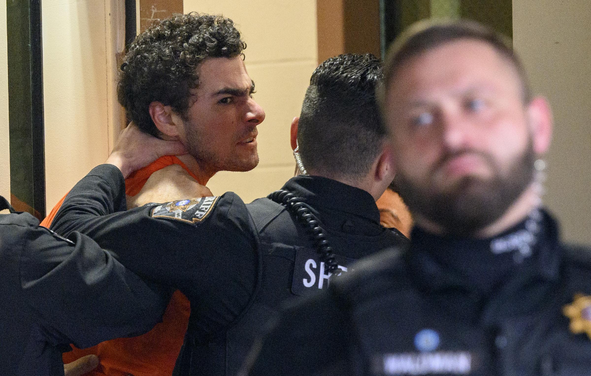 Luigi Mangione is escorted inside the Blair County Courthouse for an extradition hearing December 10, 2024, in Hollidaysburg, Pennsylvania. | Source: Getty Images