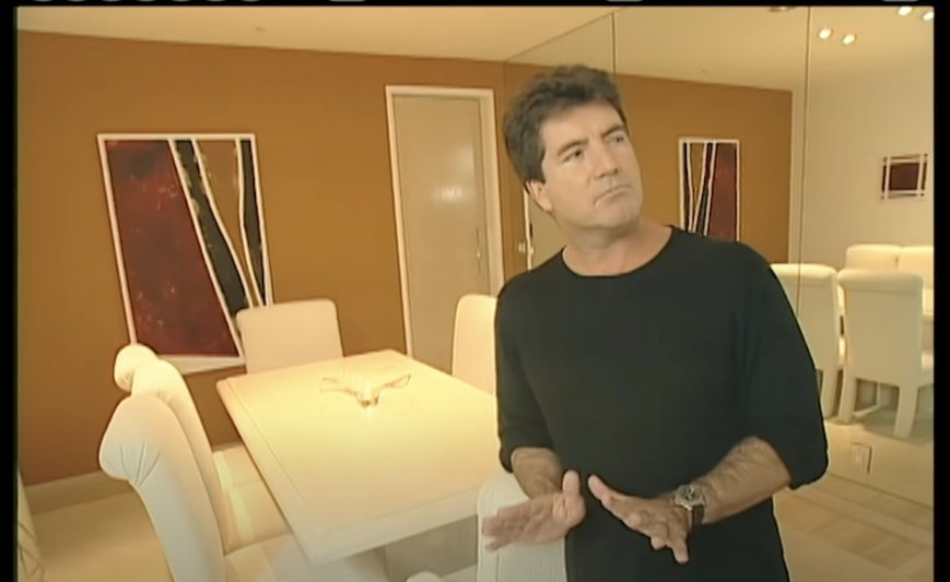 Simon Cowell showing off the dining room of his Los Angeles, California home on "MTV Cribs" in 2002 | Photo: YouTube/MTV Vault