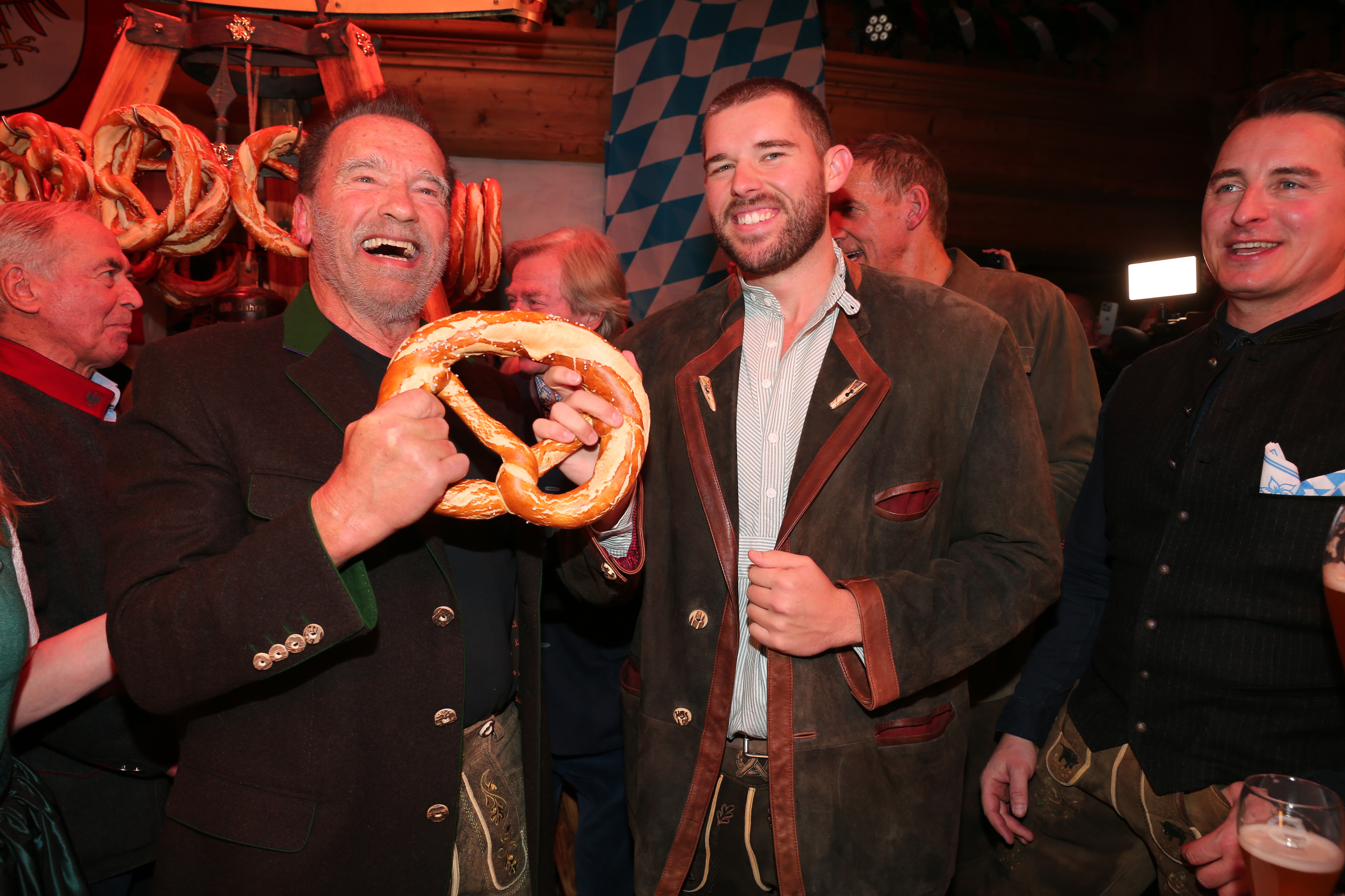 Arnold and Christopher Schwarzenegger, among other people, at the 31st Weißwurstparty in Kitzbuehel, Austria on January 19, 2024. | Source: Getty Images
