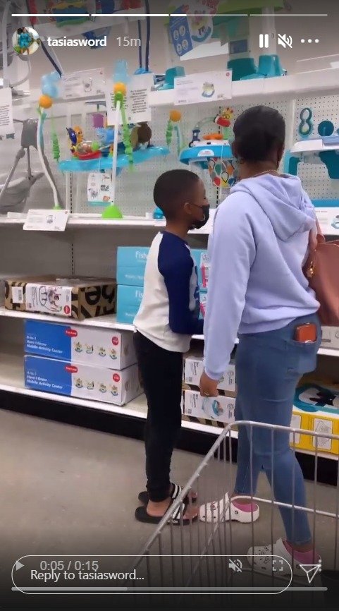 Fantasia Barrino and son Dallas Xavier looking at baby chairs at a store. | Photo: Instagram/tasiasword