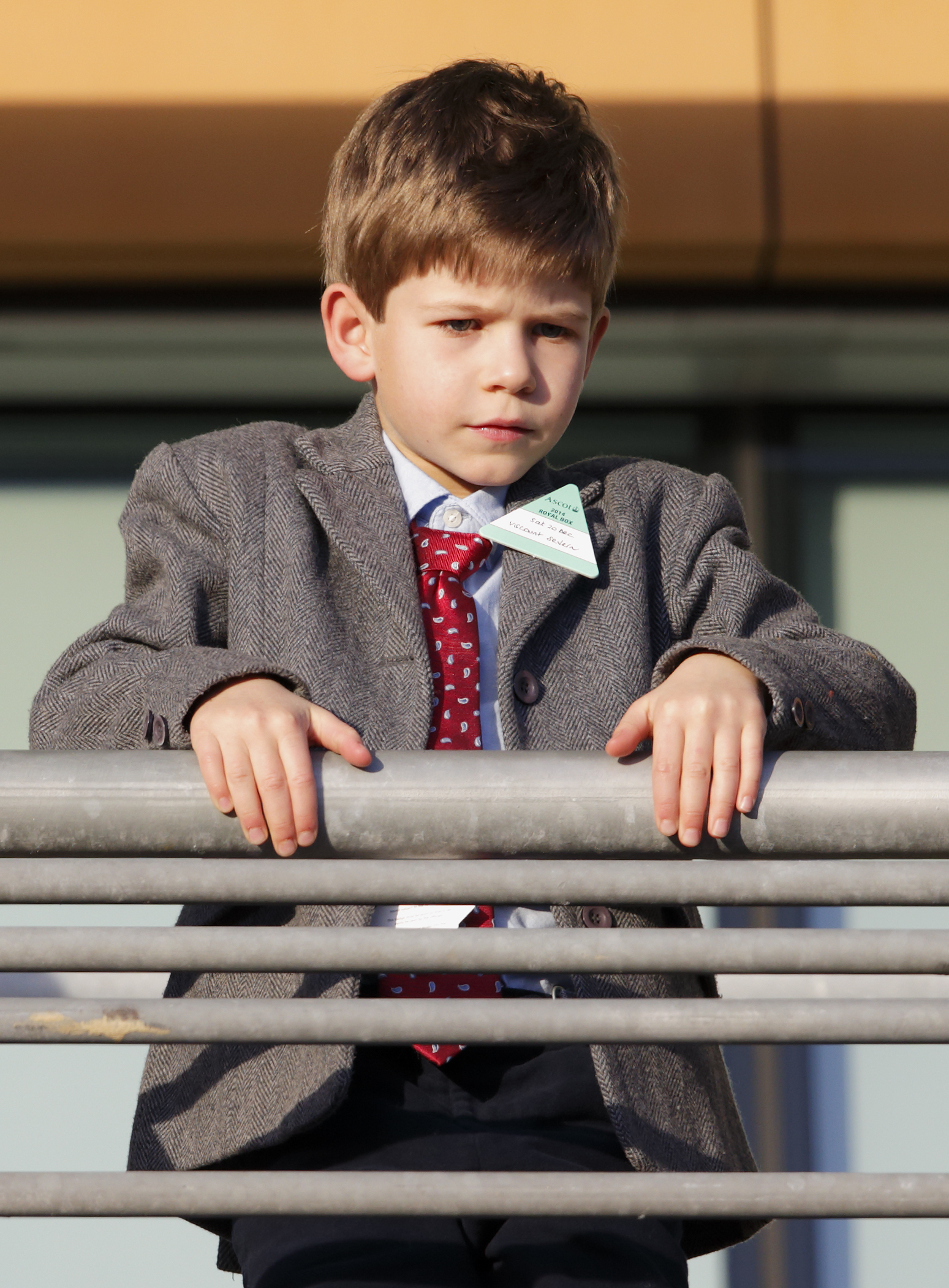 Looking ahead with curiosity: Looking sharp in his winter coat, James watches the action unfold at Ascot's Christmas Meeting in 2014. With his father nearby, the young royal took in the festive racing tradition with quiet confidence.