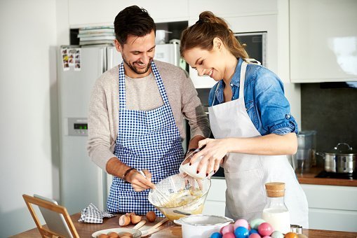 A couple baking cookies in the kitchen | Photo: Getty Images