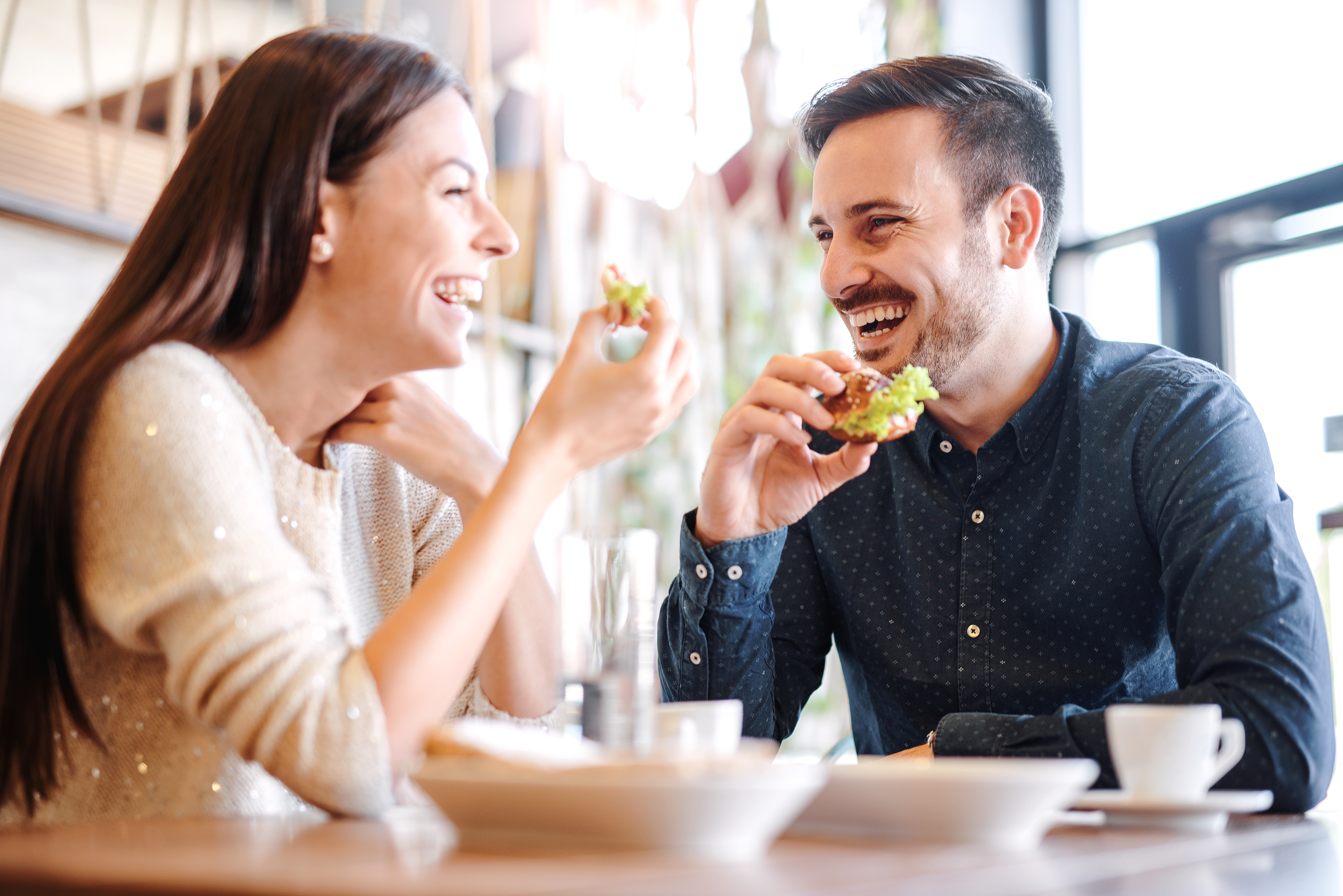 A happy couple enjoying food in a restaurant | Source: Shutterstock