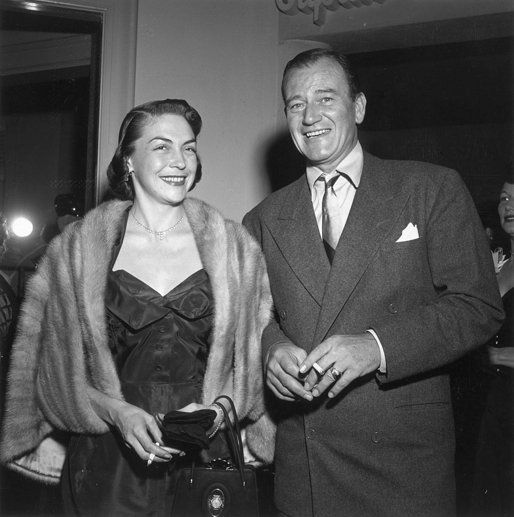 John Wayn and his second wife Esperanza Bauer at a party for American comedian Red Skelton's television debut on January 01, 1951, Hollywood, California | Photo: Getty Images