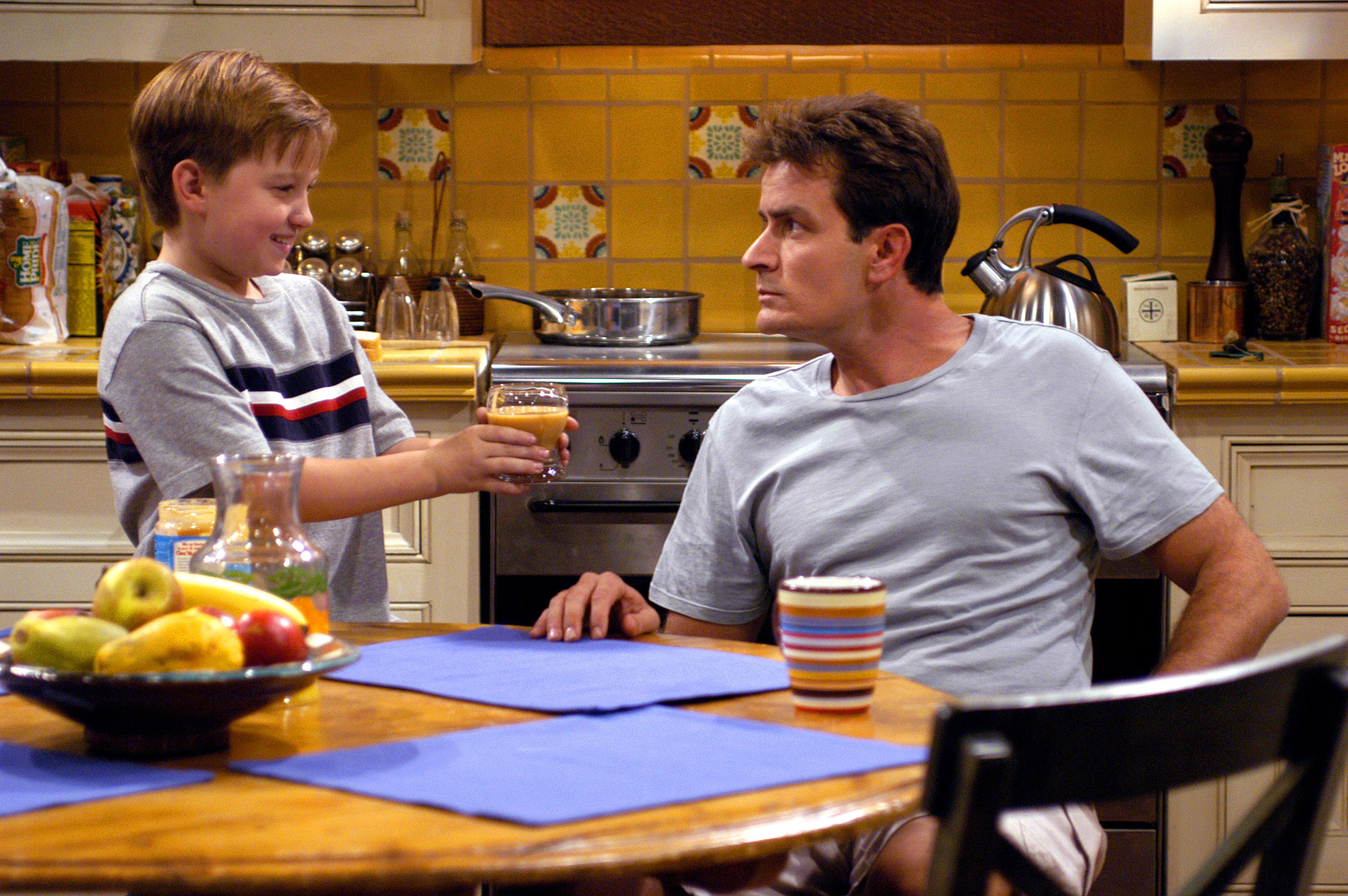 Angus T. Jones and Charlie Sheen on "Two and A Half Men" in 2003 | Source: Getty Images