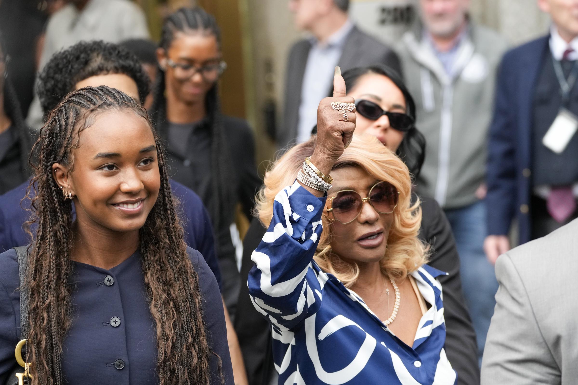 Outside the Manhattan Federal Court, Janice Combs appears to flash a thumbs-up as Chance Combs walks beside her, smiling. Their body language suggests calm confidence following the verdict.
