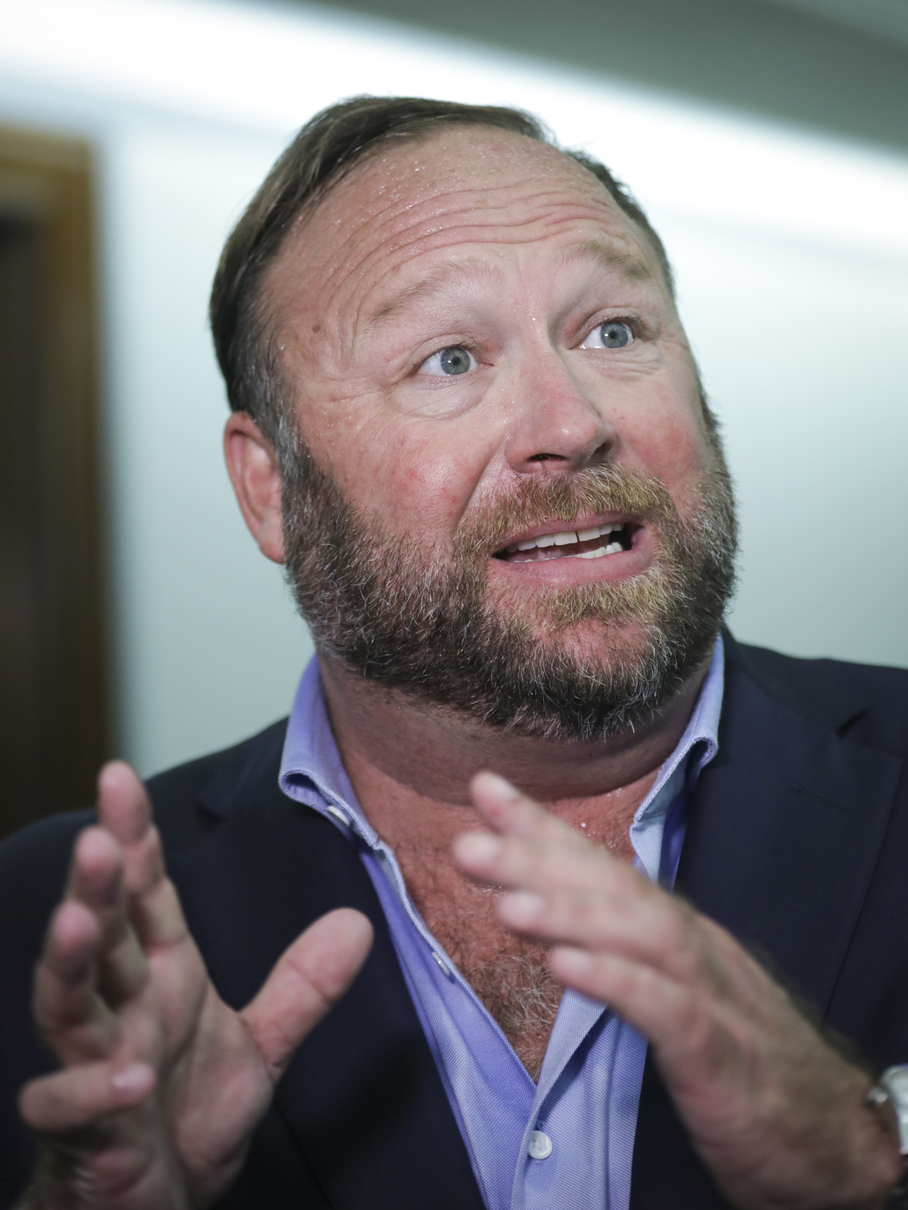 Alex Jones talks to reporters outside a Senate Intelligence Committee hearing concerning foreign influence operations' use of social media platforms, on Capitol Hill, September 5, 2018, in Washington, DC. | Source: Getty Images