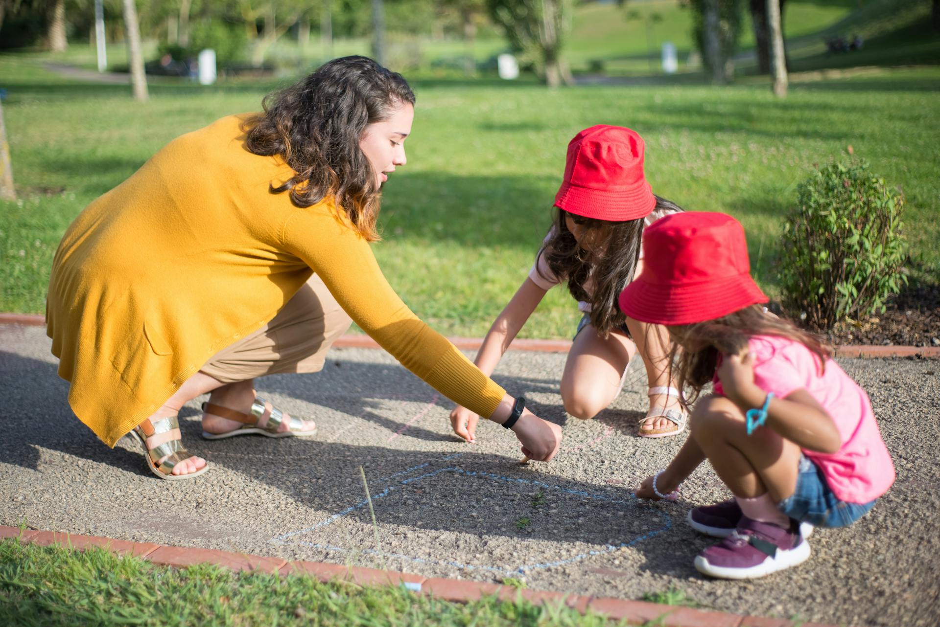 A woman playing with kids in a park | Source: Pexels