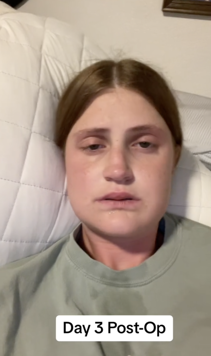 Virginia Elder sits upright at home, cheeks puffed and eyes teary, navigating recovery. | Source: TikTok/virginiaeelder