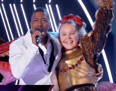 JoJo Siwa revealed to be the T-Rex on "The Masked Singer" on March 25, 2020. | Source: YouTube/ The Masked Singer.