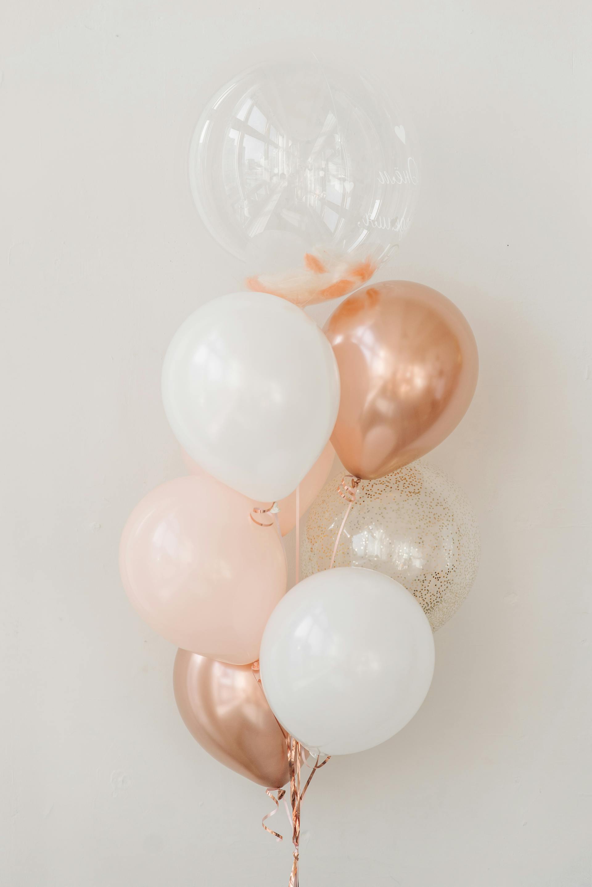 Balloons beside a white wall | Source: Pexels