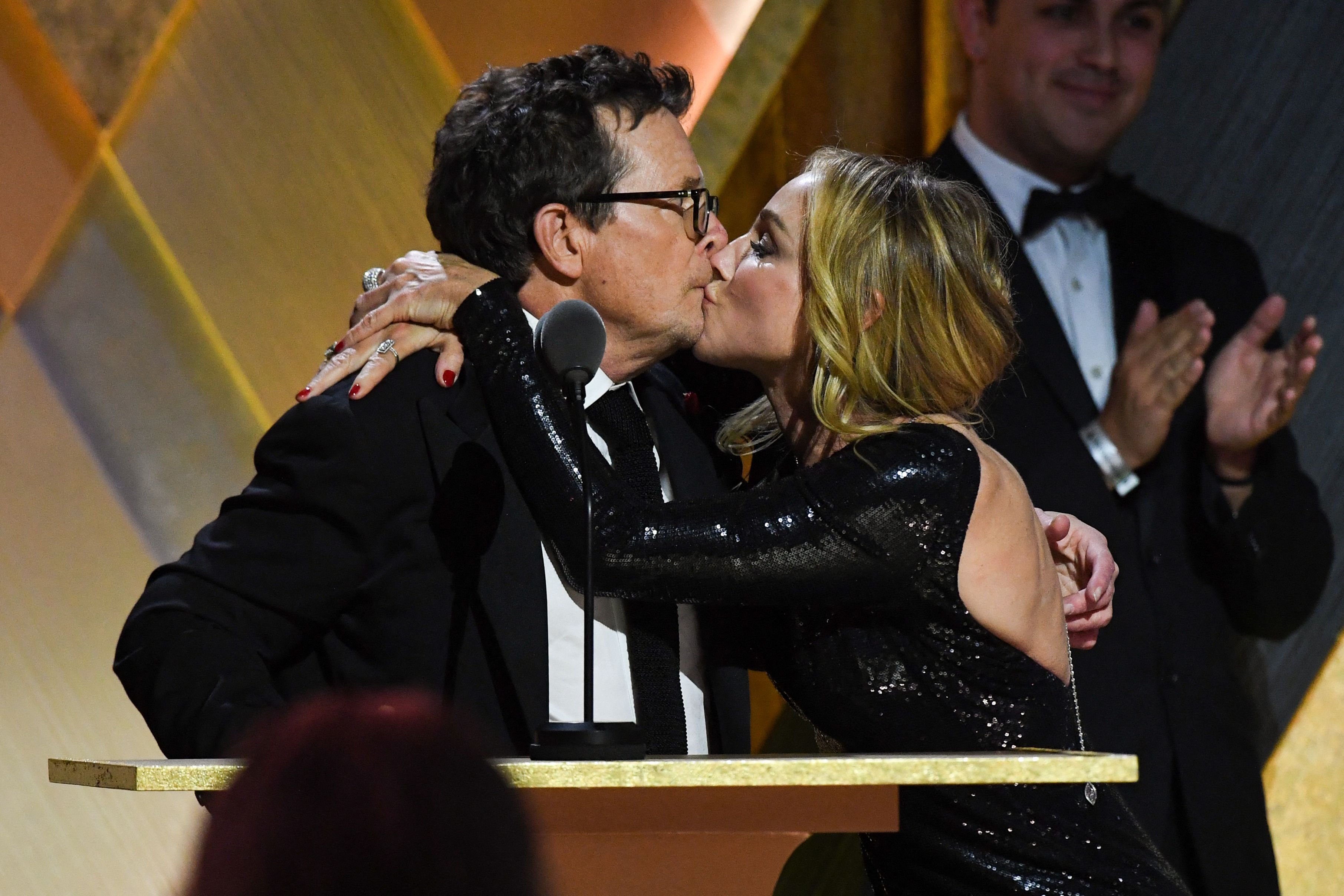 Michael J. Fox kisses his wife Tracy Pollan as he accepts the Jean Hersholt Humanitarian Award during the Academy of Motion Picture Arts and Sciences' 13th Annual Governors Awards at the Fairmont Century Plaza in Los Angeles on November 19, 2022. | Source: Getty Images