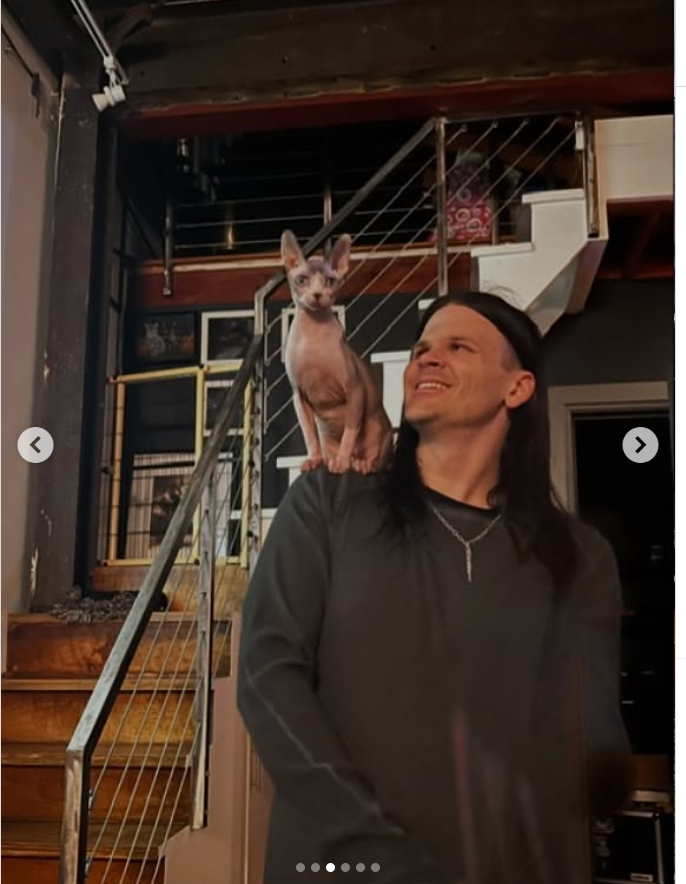 Travis Sedgwick Bacon poses with a cat on his shoulder, from a post dated June 23, 2025 | Source: Instagram/kevinbacon