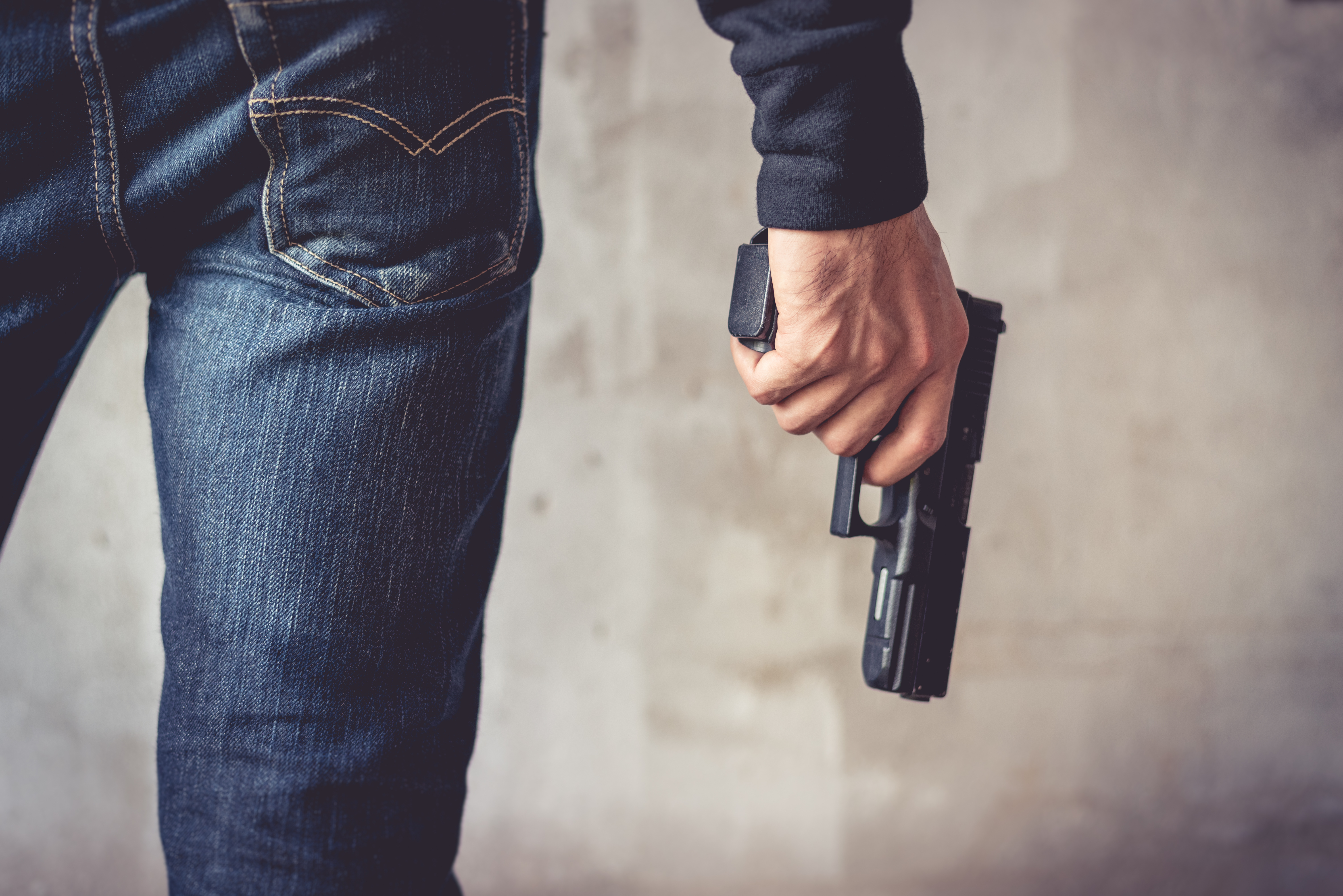 Close up of man holding hand gun | Source: Shutterstock