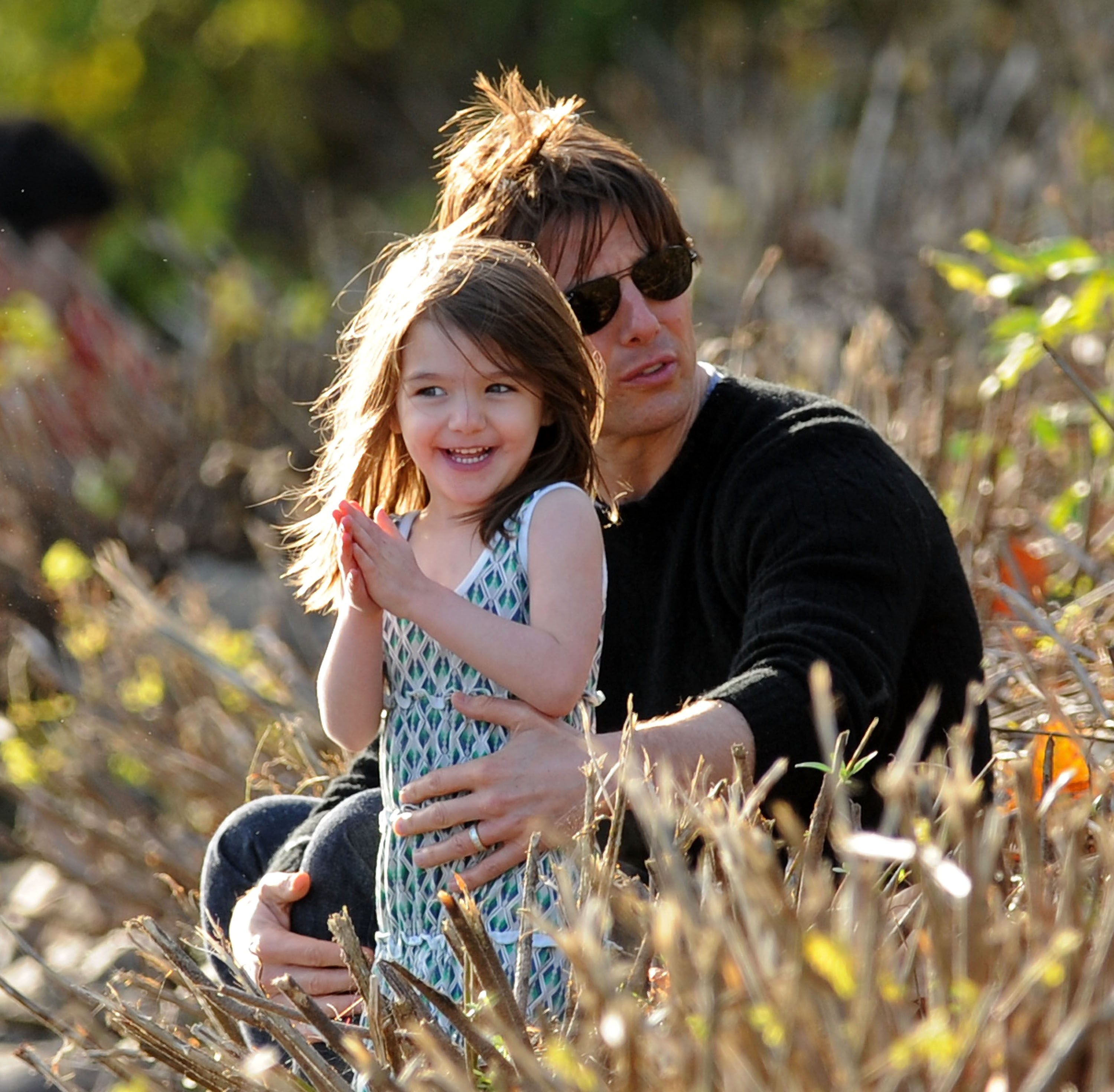 Suri Cruise and Tom Cruise visit Charles River Basin in Cambridge, Massachusetts, on October 10, 2009. | Source: Getty Images