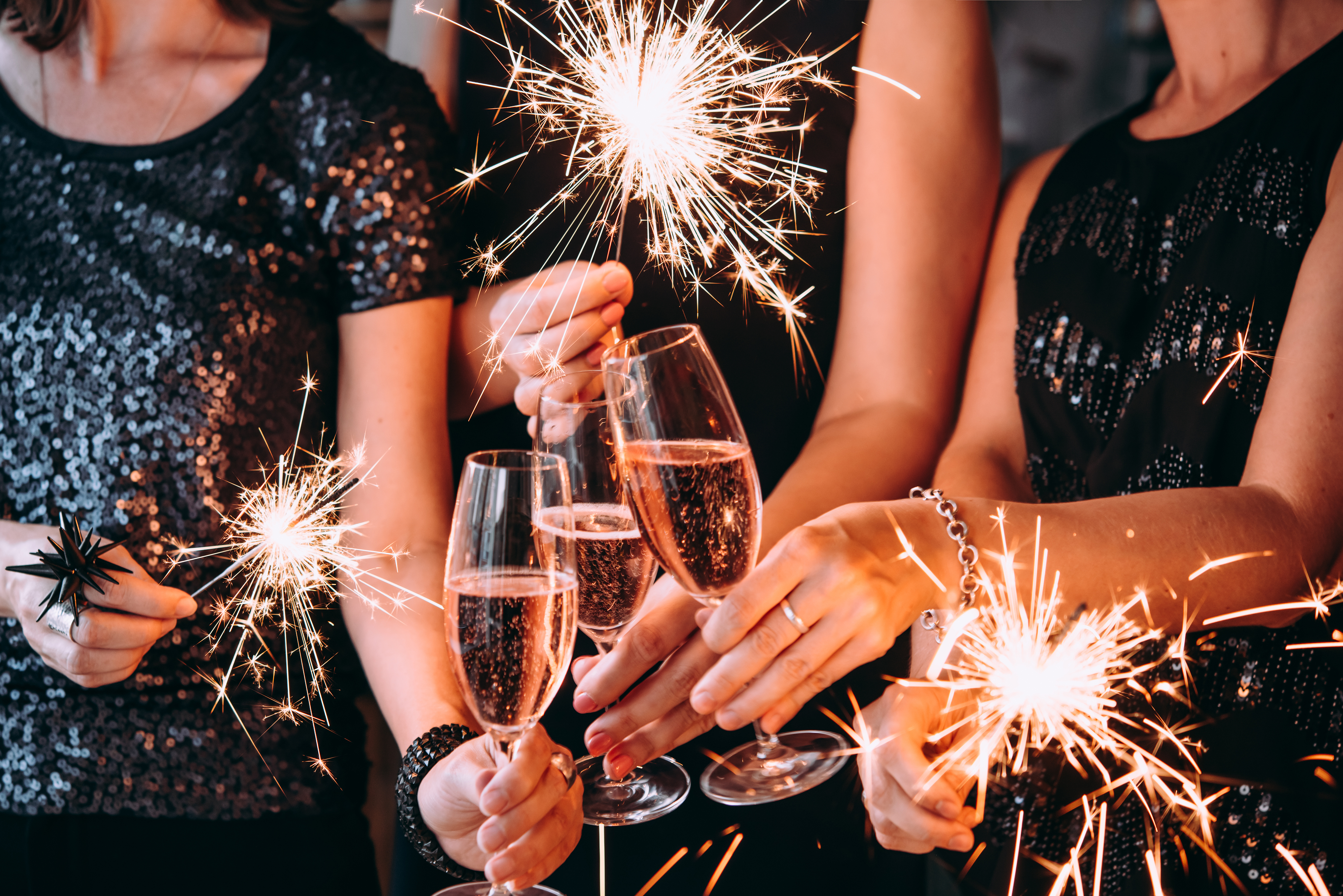 A group of friend celebrating new year with Bengal lights and rose champagne | Source: Shutterstock