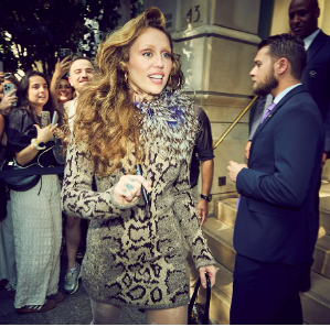 Miley Cyrus engaging with fans as security detail stand nearby. | Source: Instagram/mileycyrus
