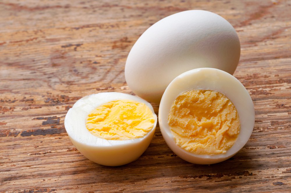 Two boiled eggs and one is cut in half. | Photo: Shutterstock